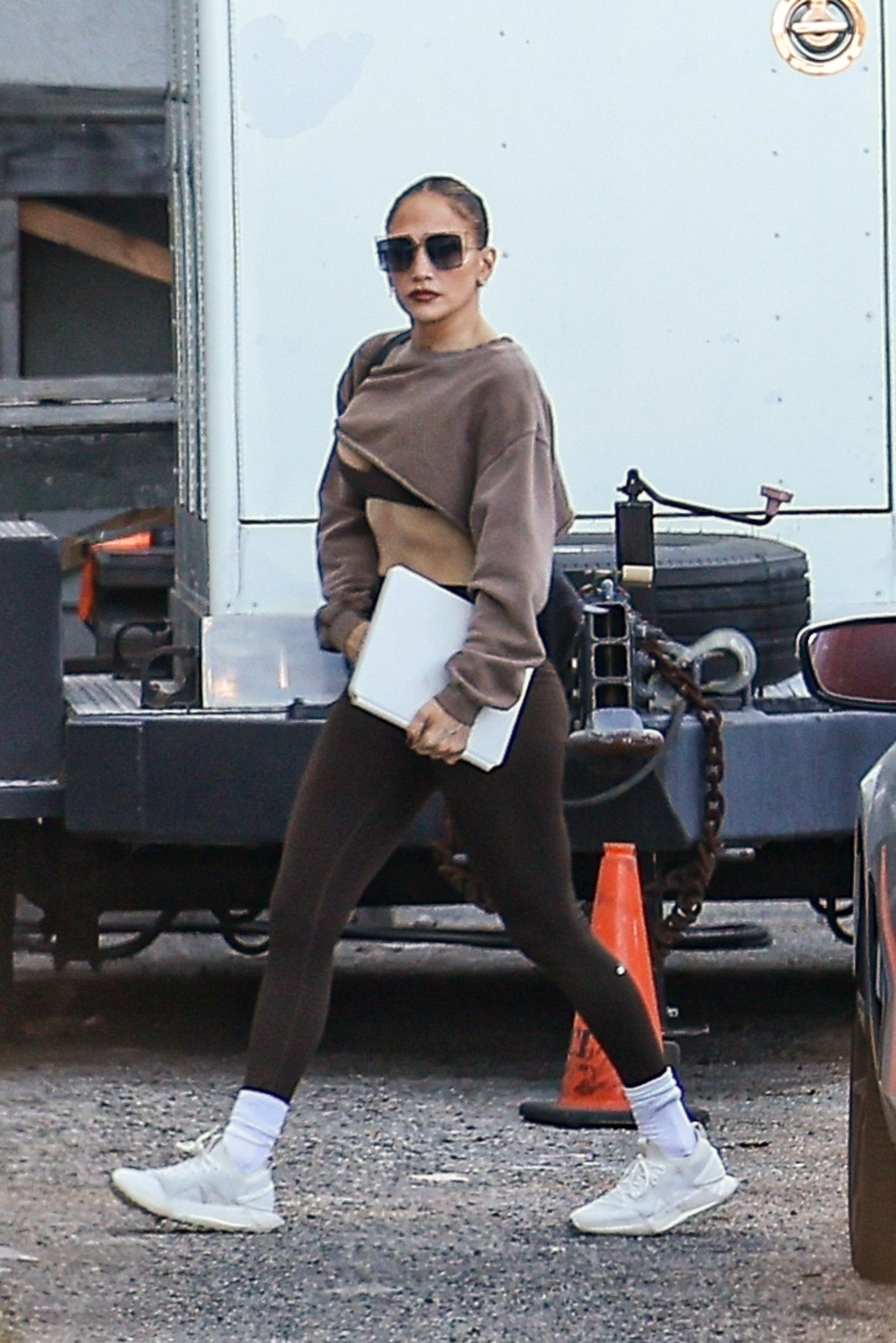 Jennifer Lopez wearing brown leggings with white sneakers.