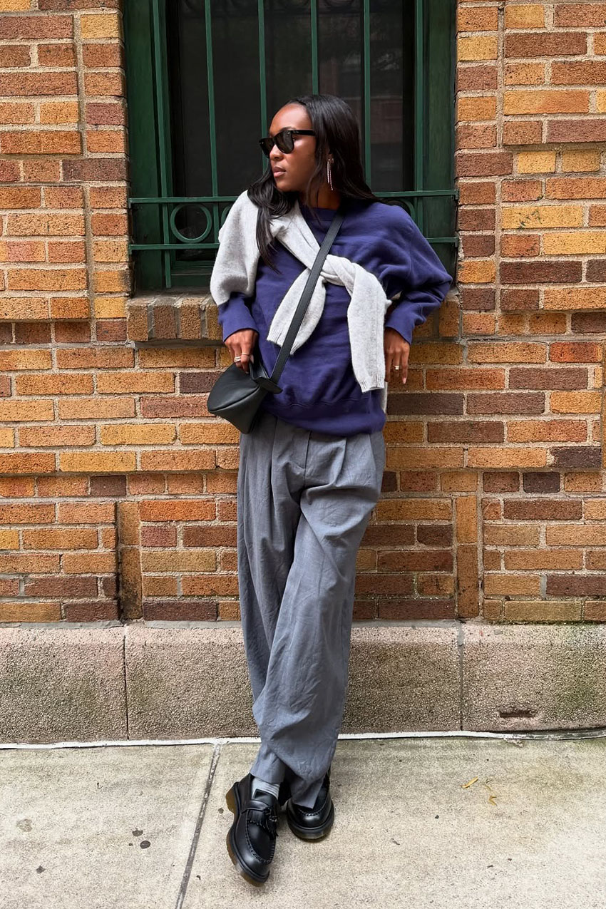 a woman wearing black loafers