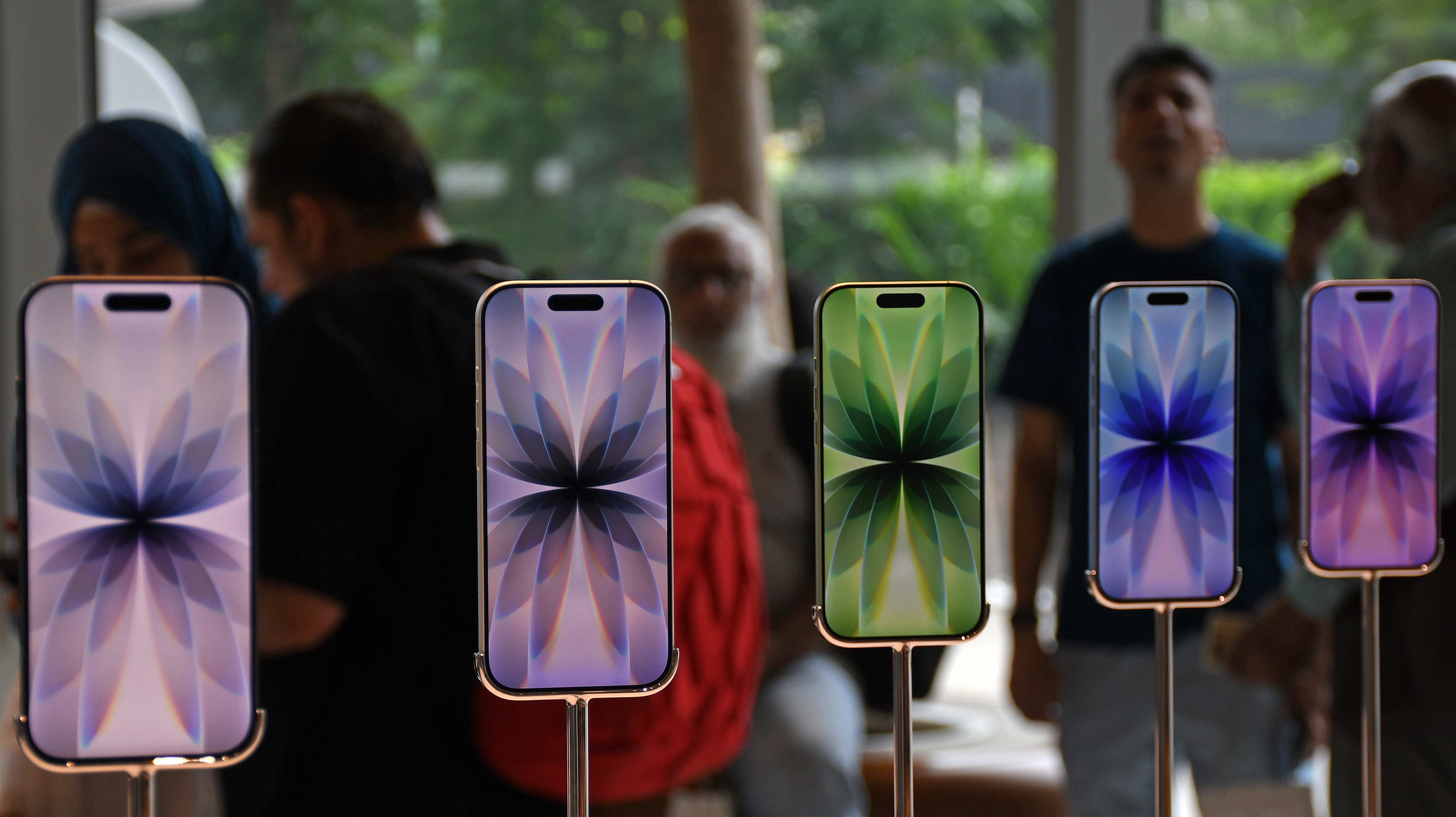 Models of iPhone 17 series mobile phones seen on display...