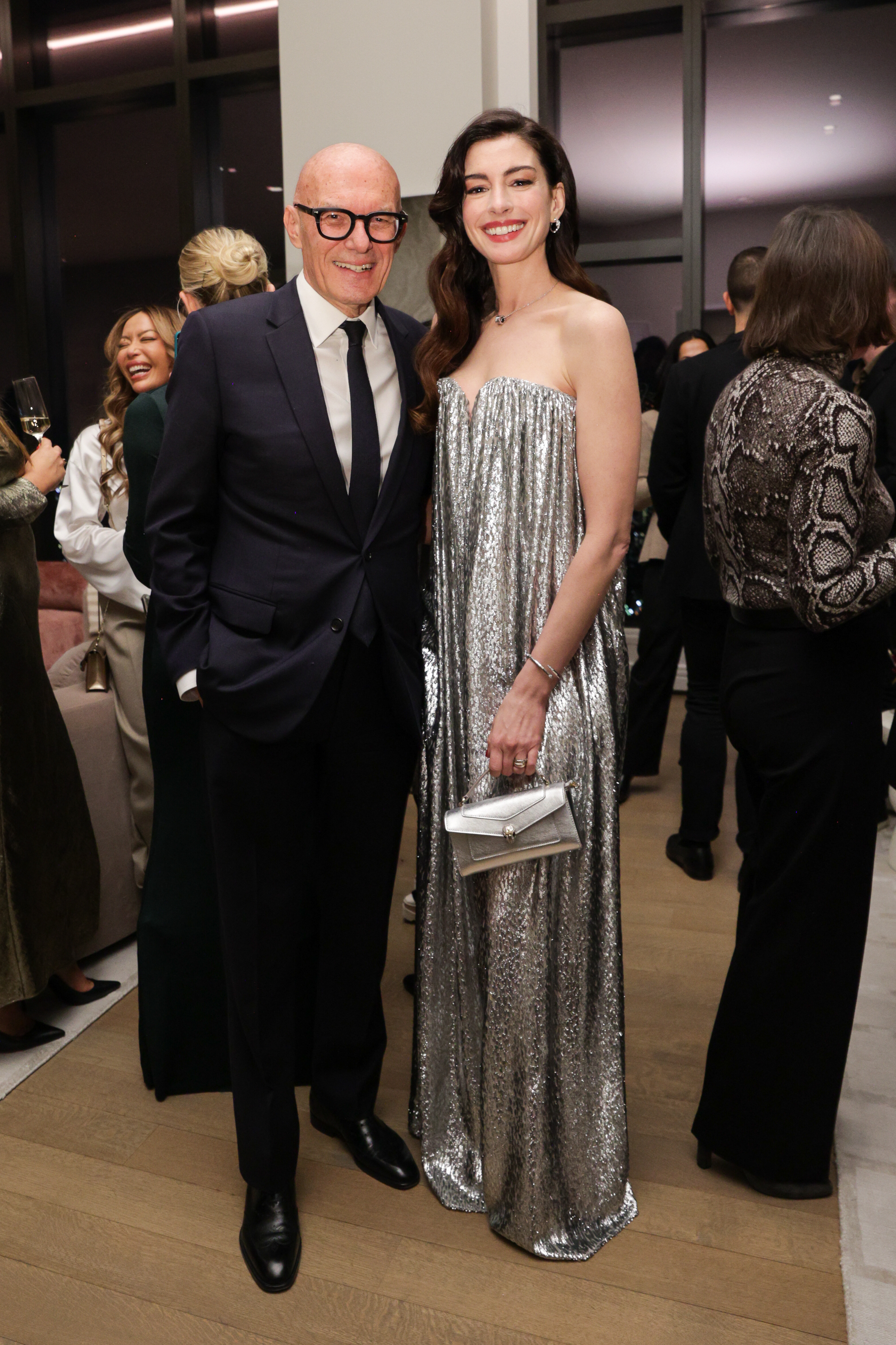 Anne Hathaway wears a silver maxi dress
