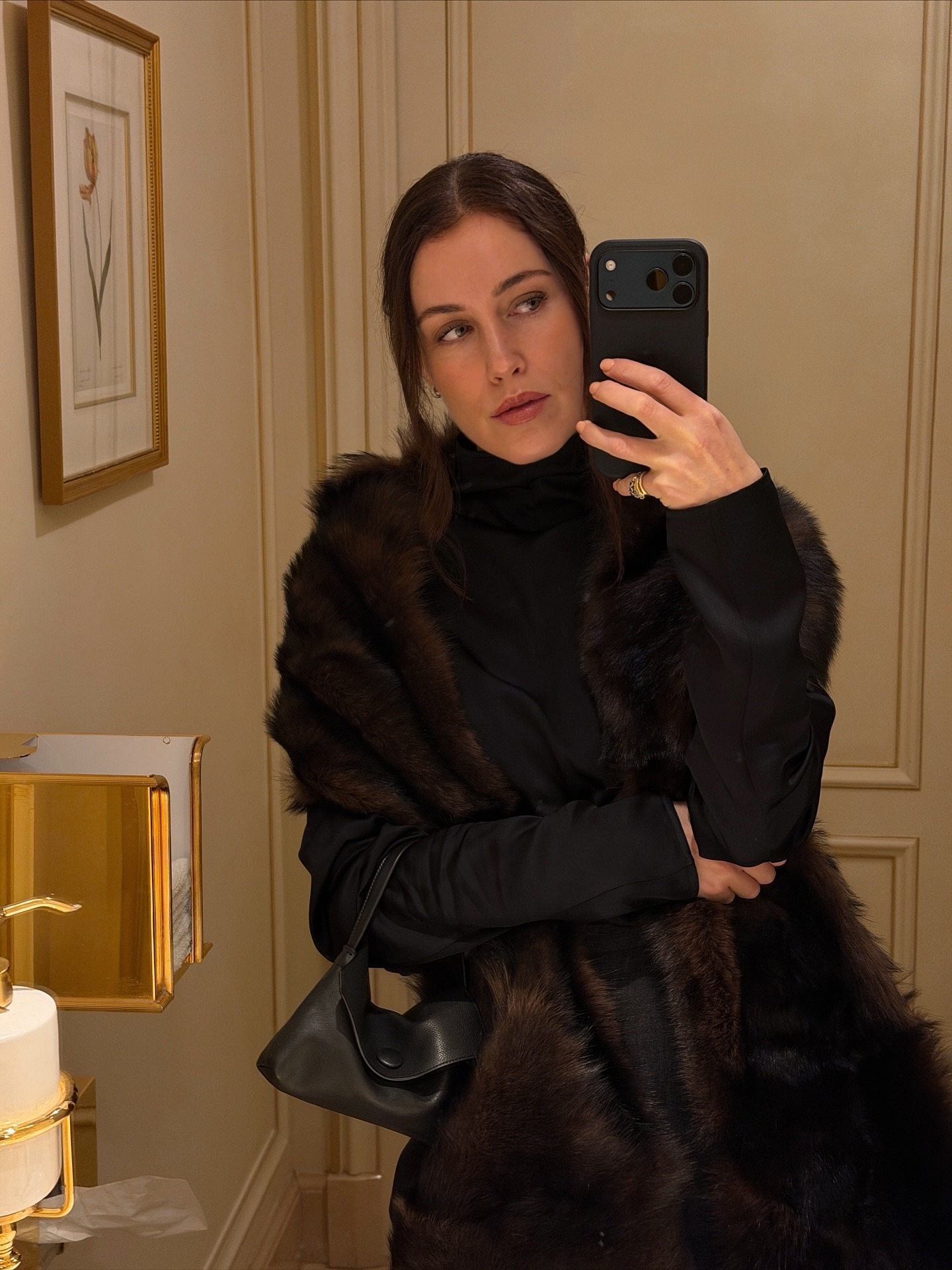 Annabel wears a fur coat and the row sally bag.