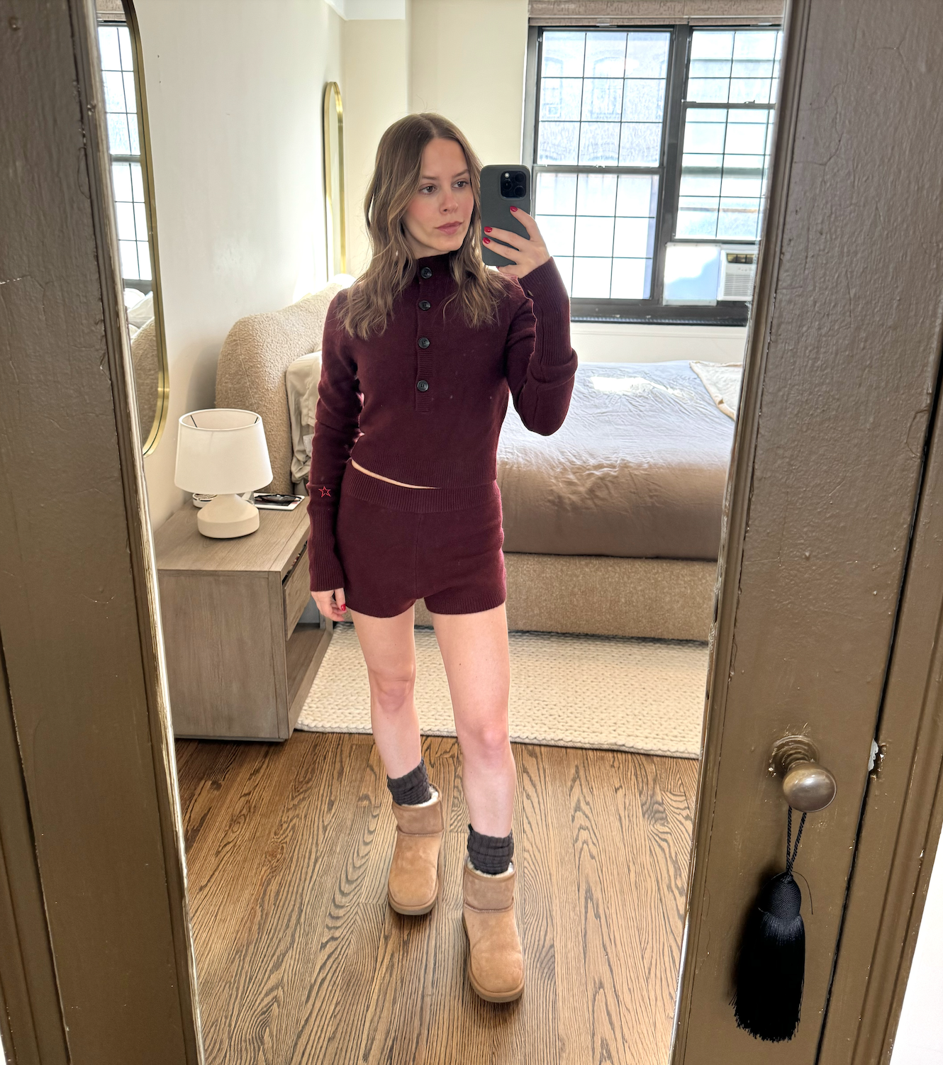Nikki tries on a burgundy button down sweater and shorts.