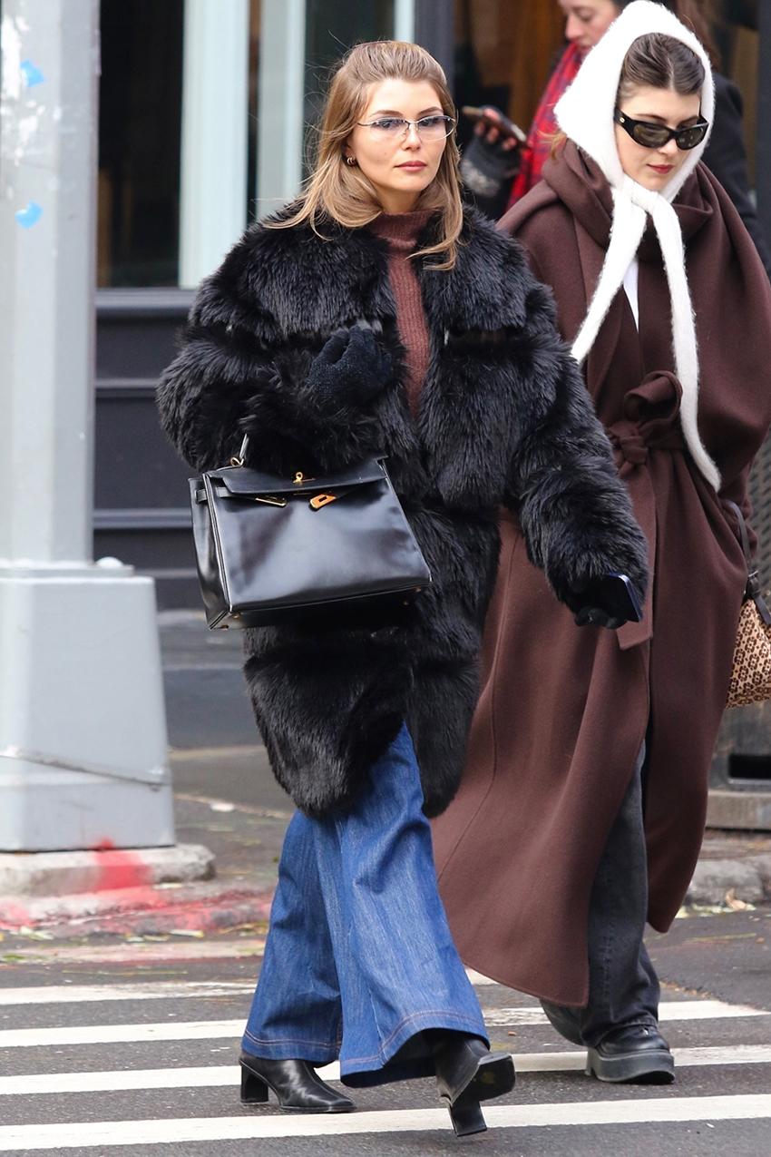 Olivia Jade wearing a black fur coat, brown turtleneck, jeans, a structured frame bag, and black block-heel ankle boots