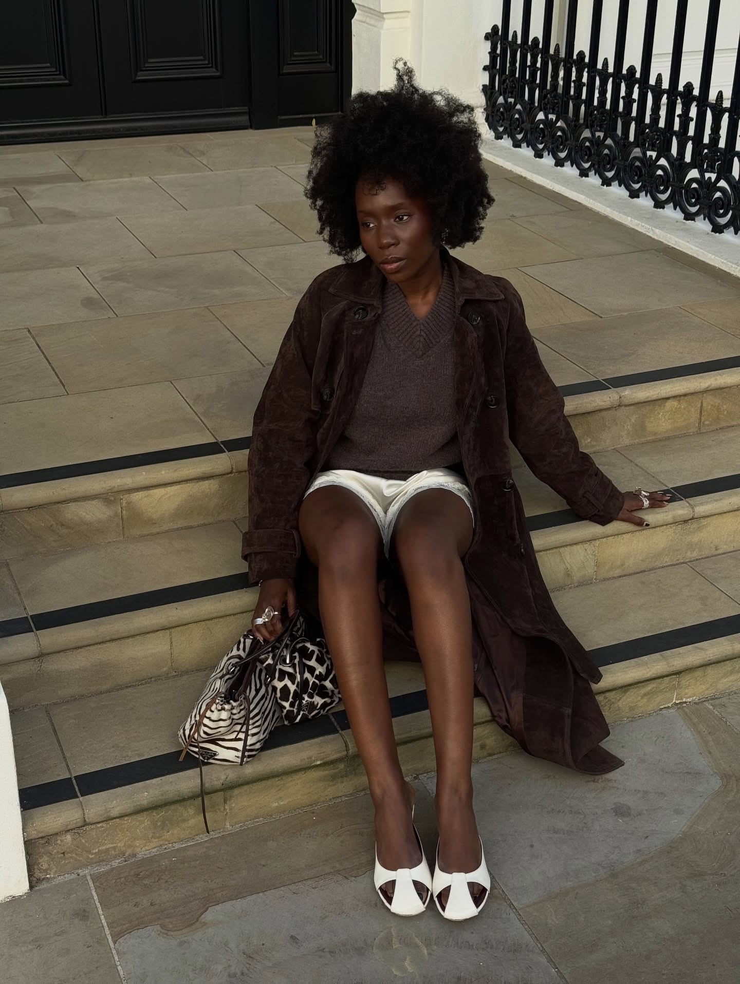 Fashion person Danielle Jinadu @daniellejinadu wears a winter microtrend 2025. she wears a high neck, v neck jumper.