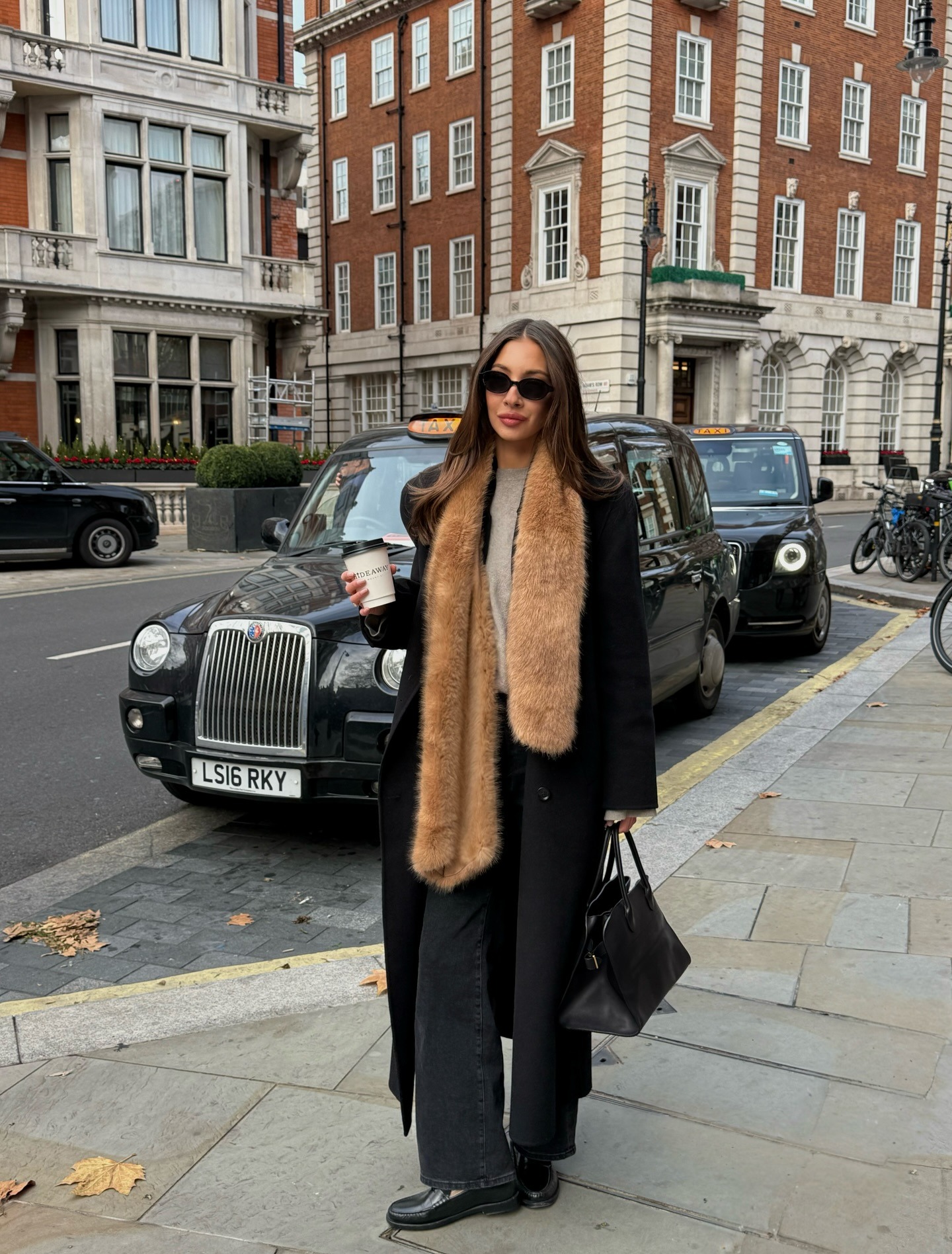 Influencer wearing a faux fur scarf with jeans and loafers