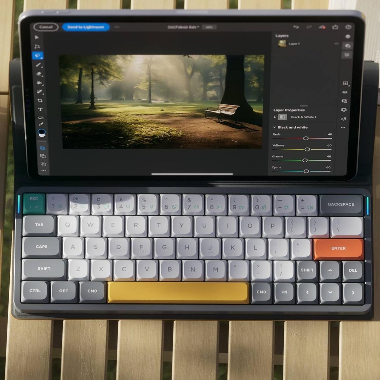 NuPhy Air60 V2 keyboard with tablet on wooden table