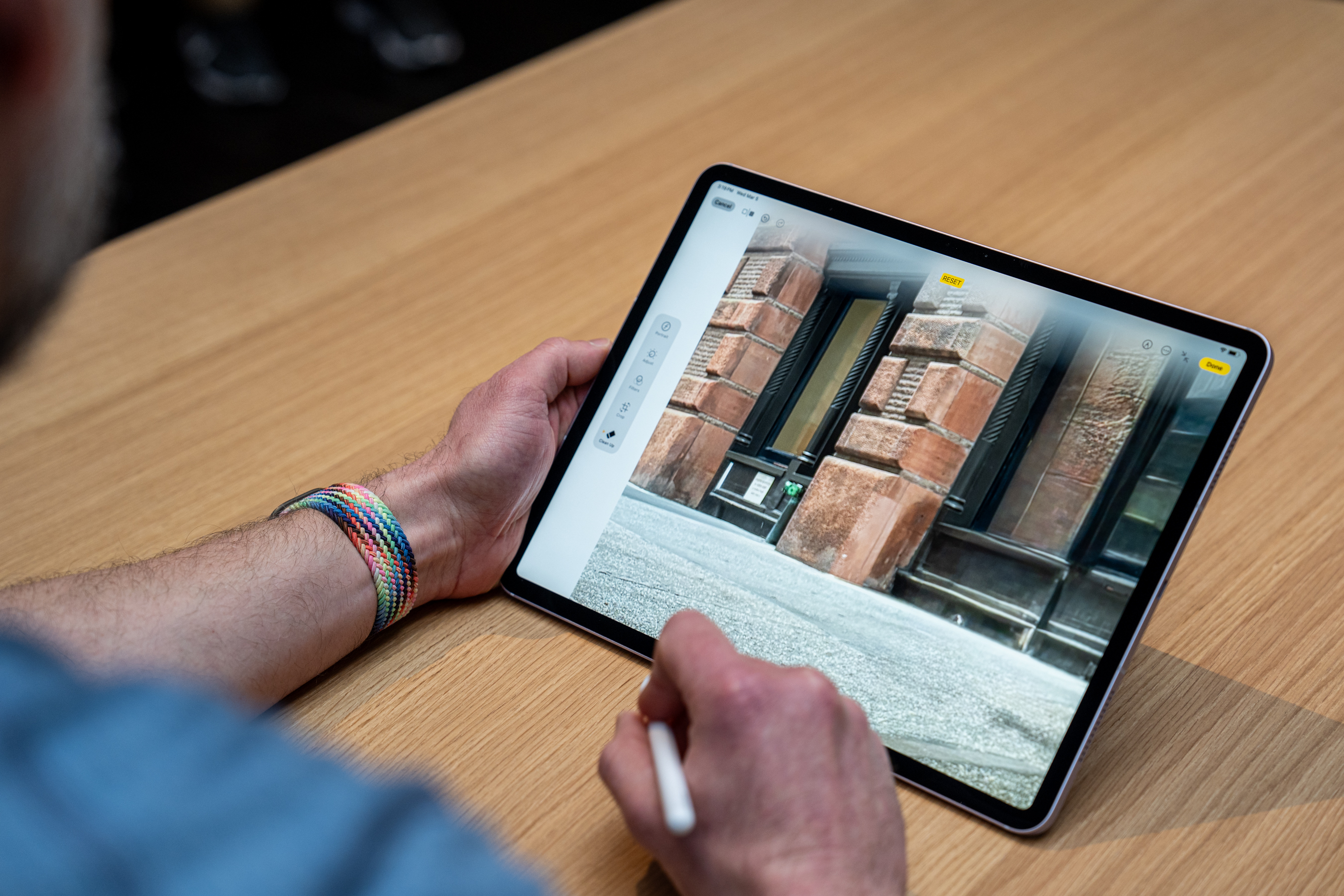 A photo of a person using an iPad Air and an Apple Pencil.