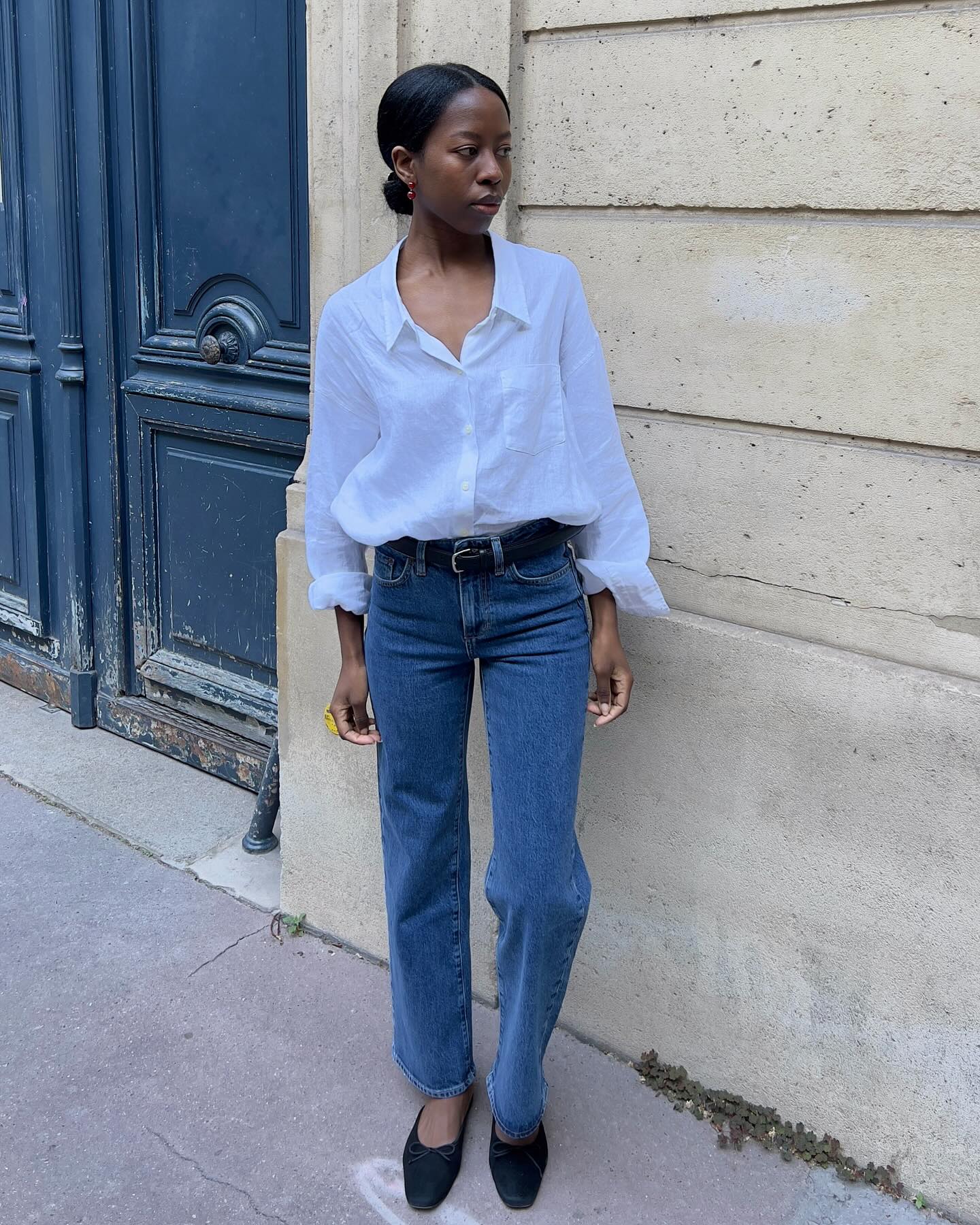 An image of @sylviemus_ wearing stovetop jeans, one of the biggest 2026 jeans trends, with round-toe ballet flats and white shirts.