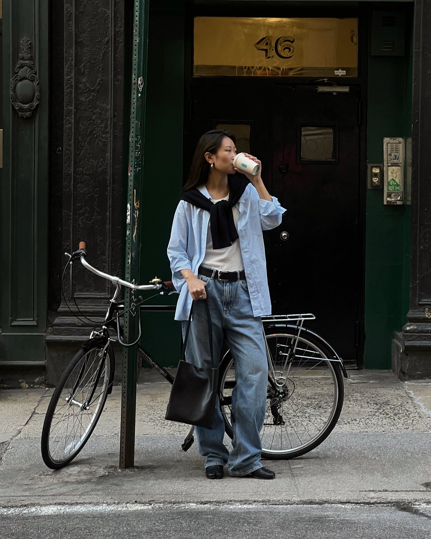 An image of @thecarolinelin wearing &#039;90s minimalistic jeans with a white t-shirt, grey shirt and navy jumper.