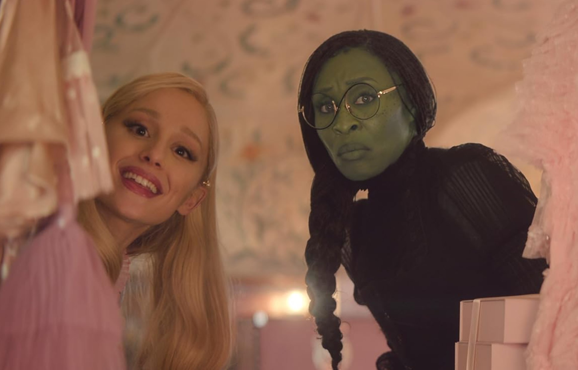A screenshot from the movie Wicked that features Galinda (Ariana Grande, left) and Elphaba (Cynthia Erivo, right).
