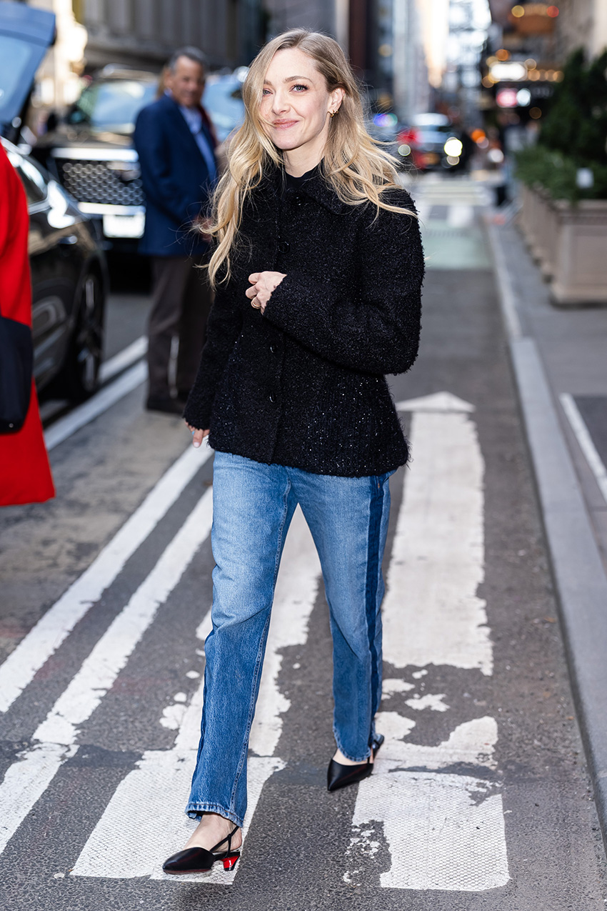 Amanda Seyfried wearing a black tweed coat, side-stripe cigarette jeans, and slingback kitten heels in NYC
