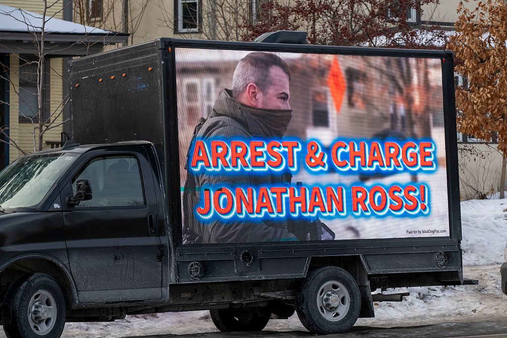 Arrest and charge Jonathan Ross sign on truck at the memorial site for Renee Good who was shot by an Immigration and Customs Enforcement officer in Minneapolis, MN