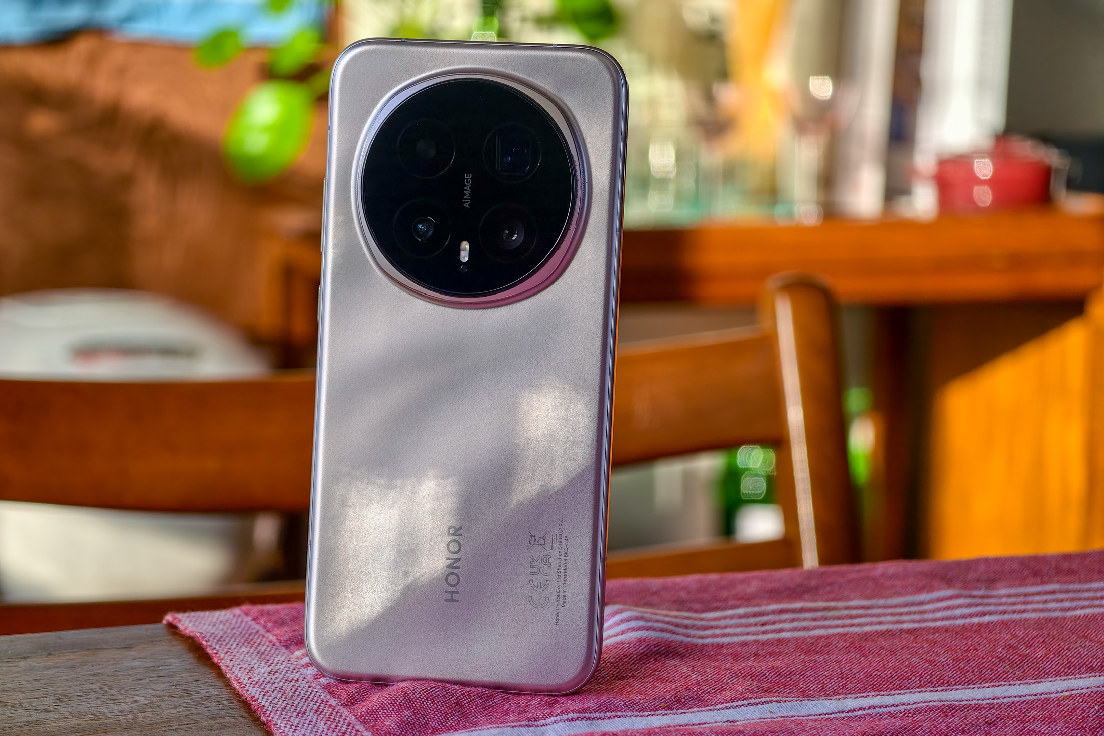 Photo of Honor Magic 8 Pro on a wooden table showing the back of the phone