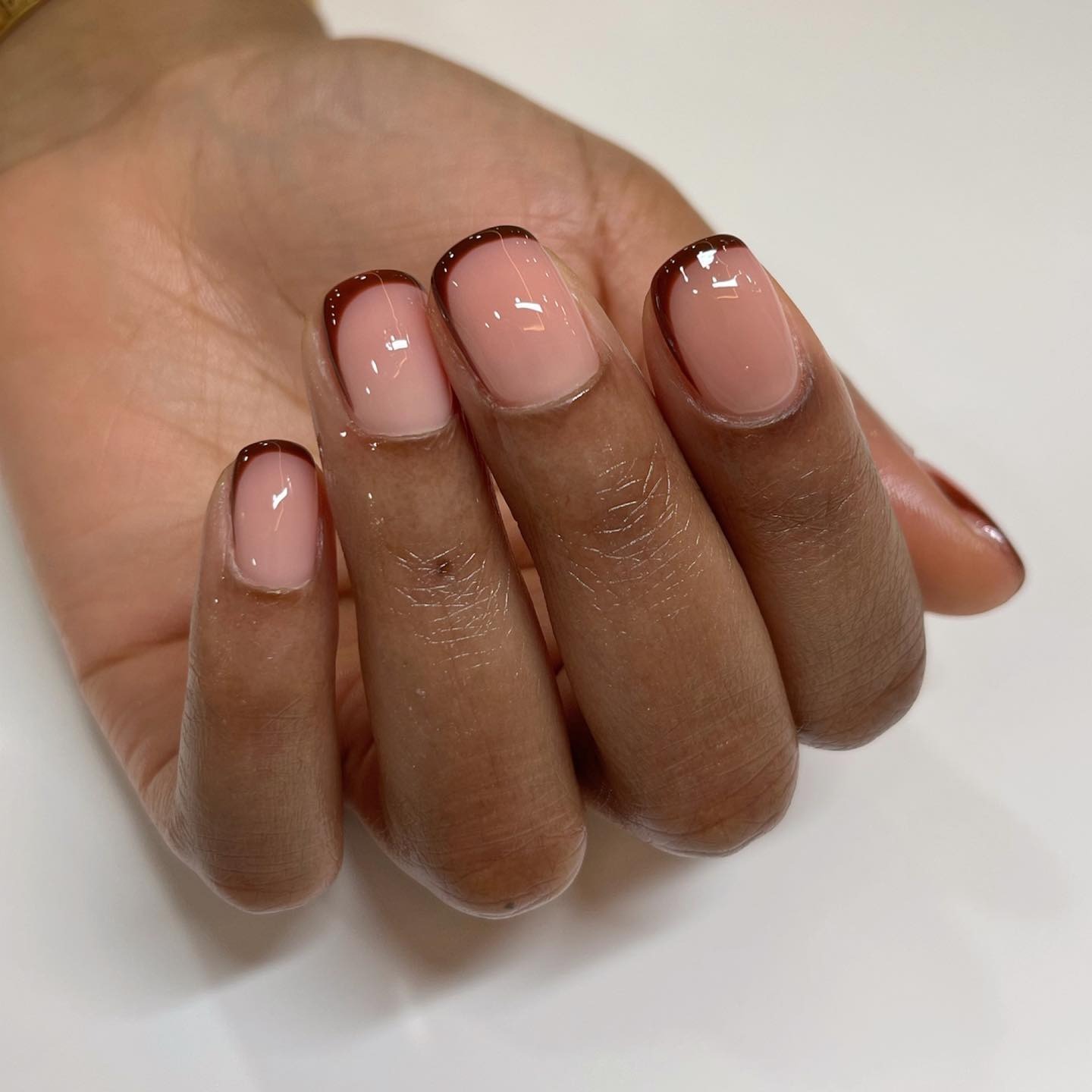 A maroon French tip manicure