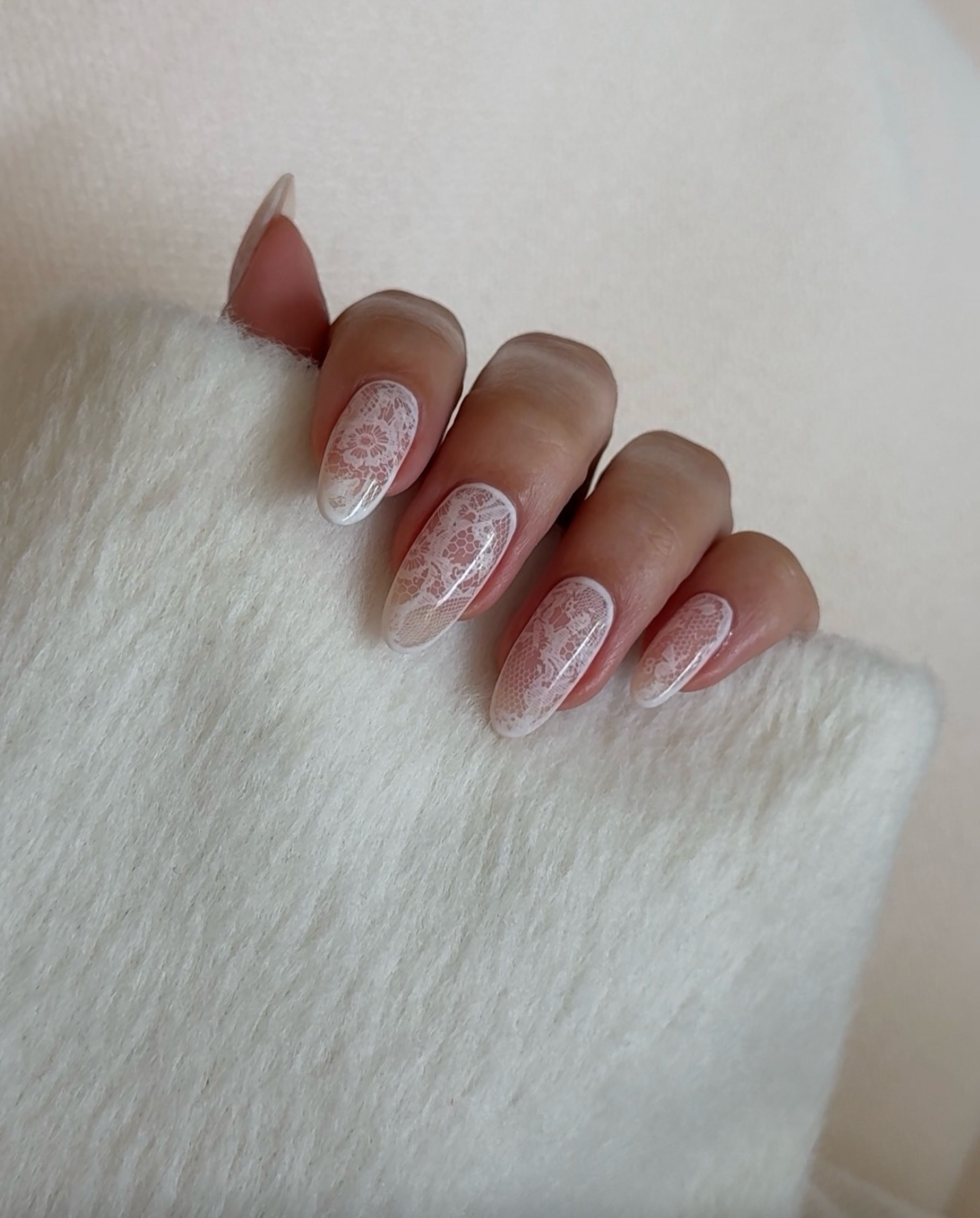 A manicure with lace nail art by Zola Ganzorigt