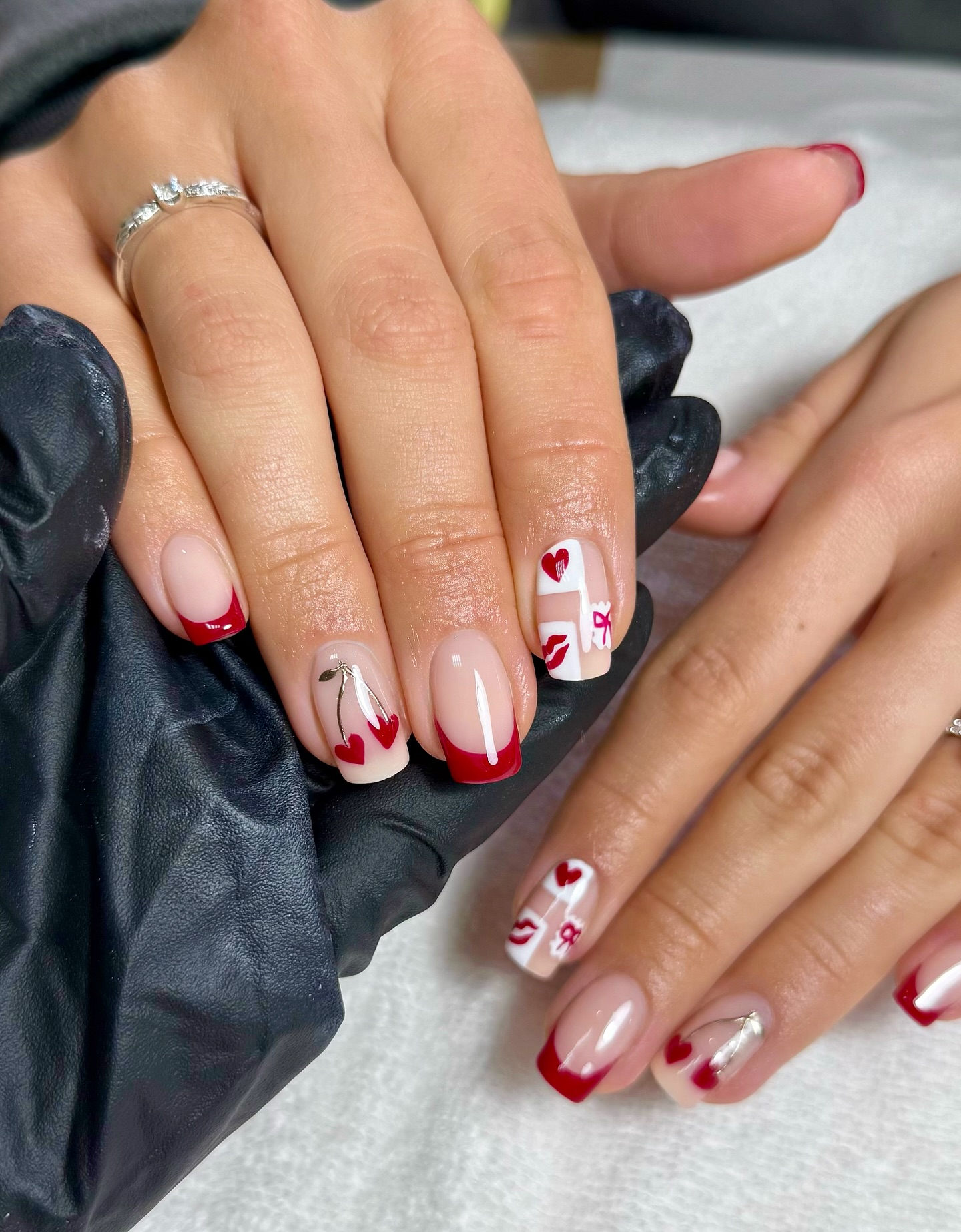 A manicure with French tips and Valentine's themed nail art by Charlotte Cliff