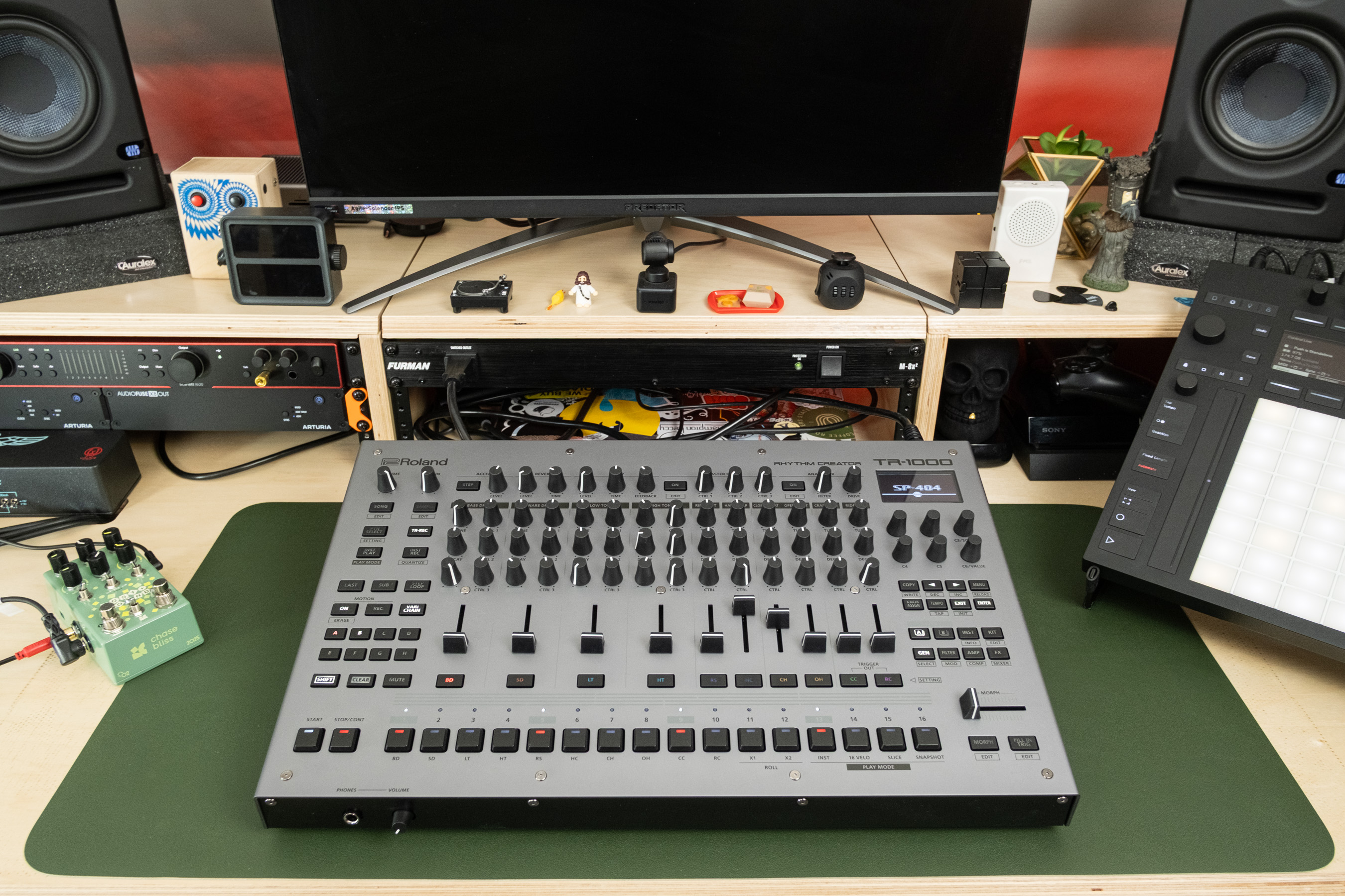 A wider shot of the TR-1000 on a desk alongside a Push 3 and a Chase Bliss Lost + Found.