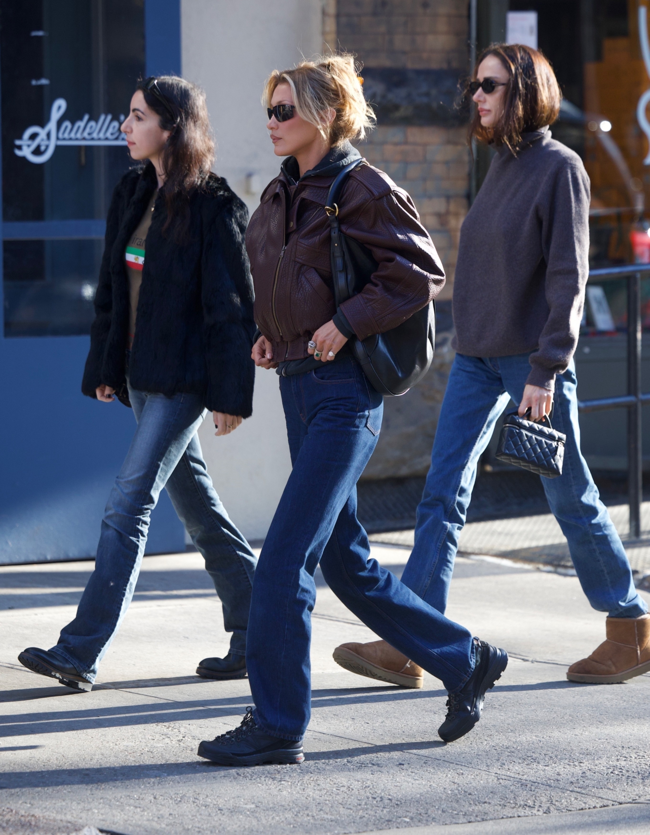 Bella Hadid was spotted at breakfast at Sadelle's in Soho on Monday afternoon with friends. The model wore a maroon leather biker jacket, which she styled over a gray hoodie, with dark denim straight-leg jeans and Salomon sneakers. She finished her look with a Saint Laurent Mombasa bag.
