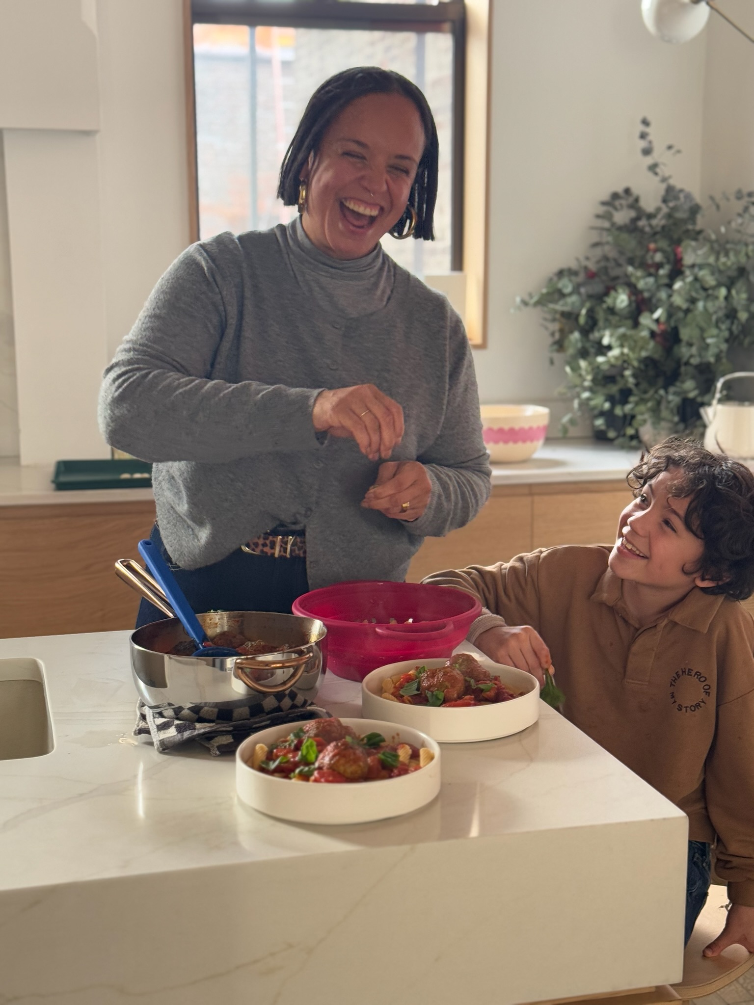 Mandela Cocores cooking with her son.