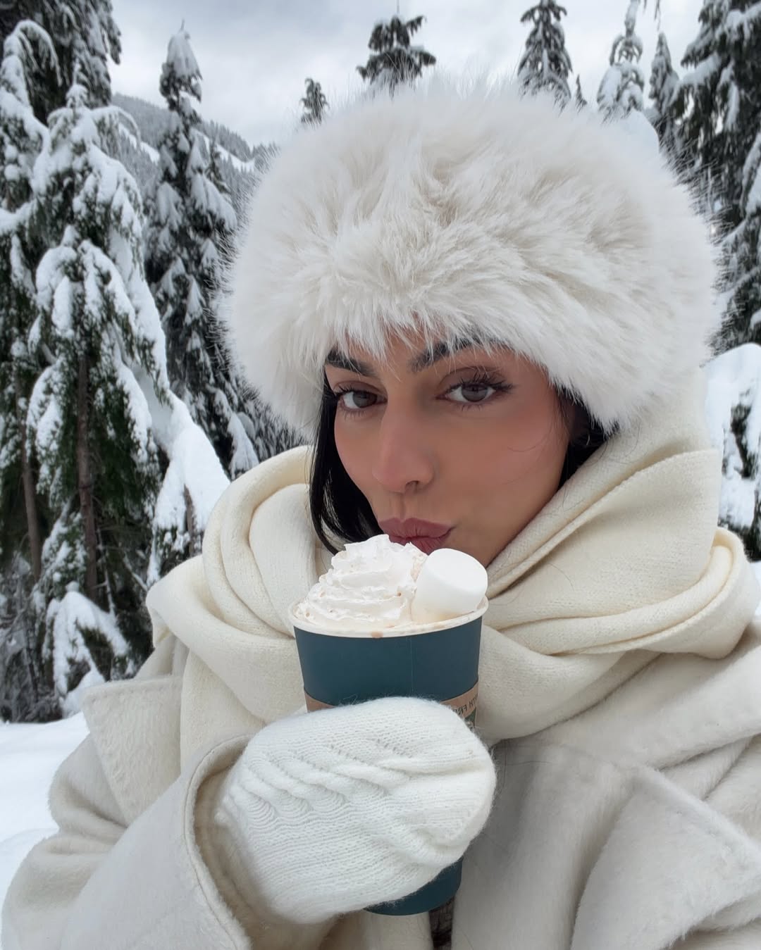 Mobina Peiman with glowy, flushed skin against a snowy background.