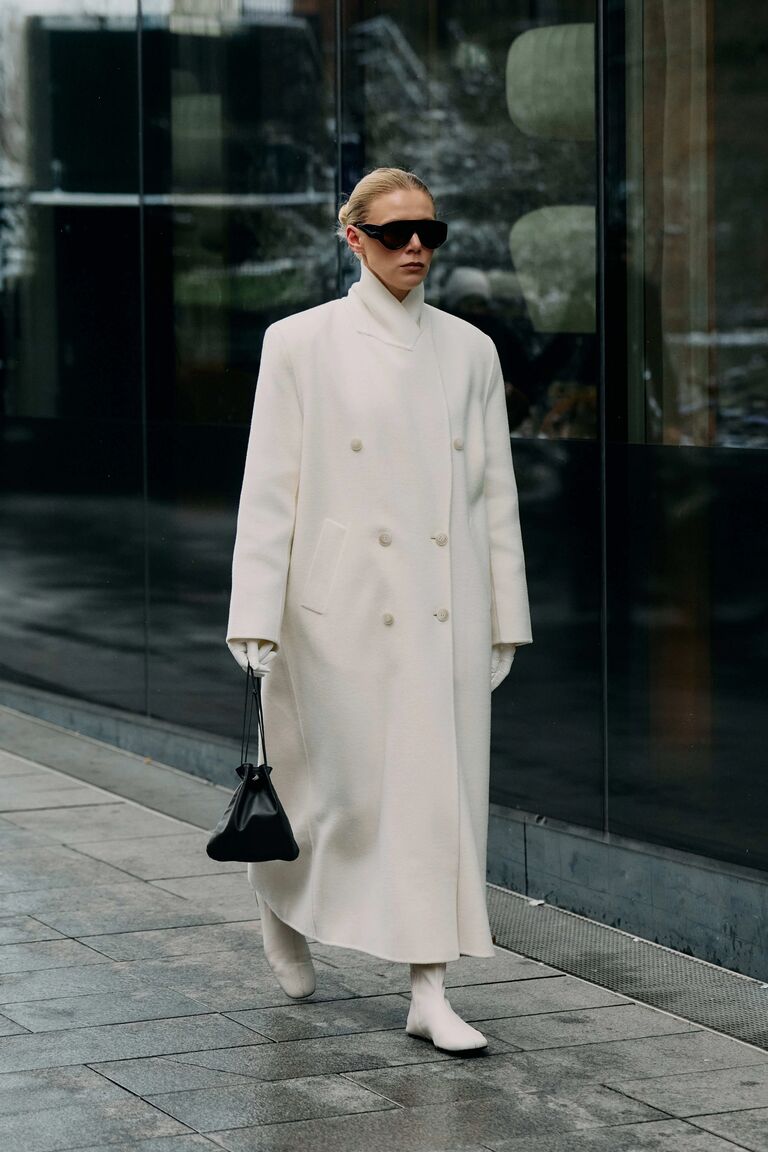 Photo of woman wearing coat at Copenhagen Fashion Week.