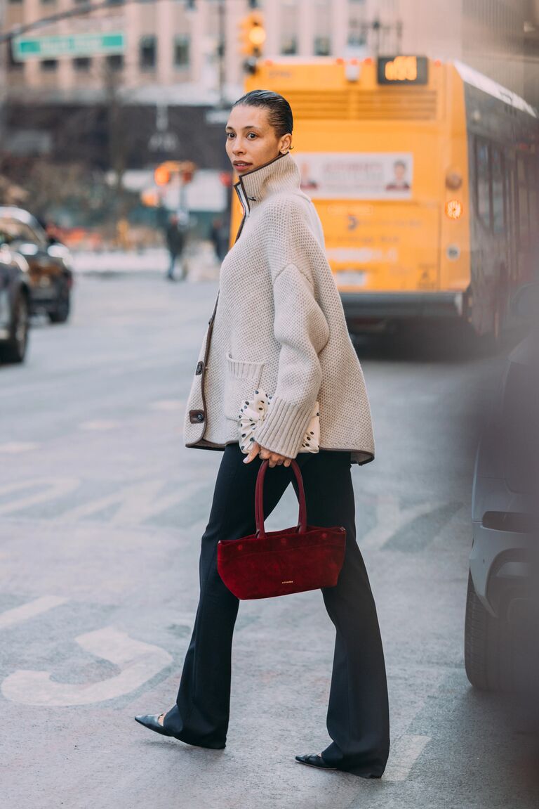 a woman wears a gray cardigan