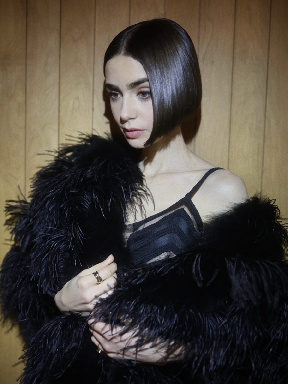 Lily Collins with a sleek glossy bob haircut