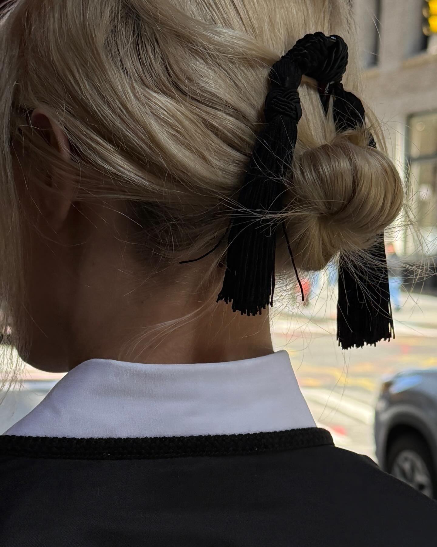An image of @christietyler wearing a fringe hair accessory, one of the biggest minimalist spring 2026 trends.