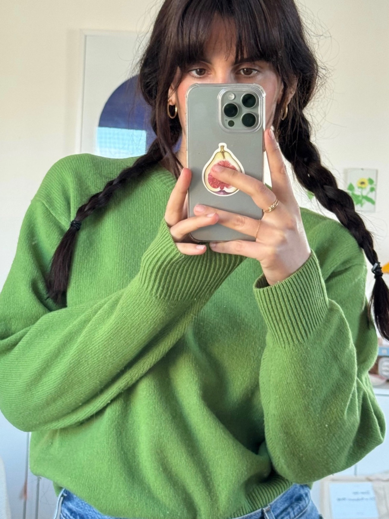 Diane wears a green sweater.