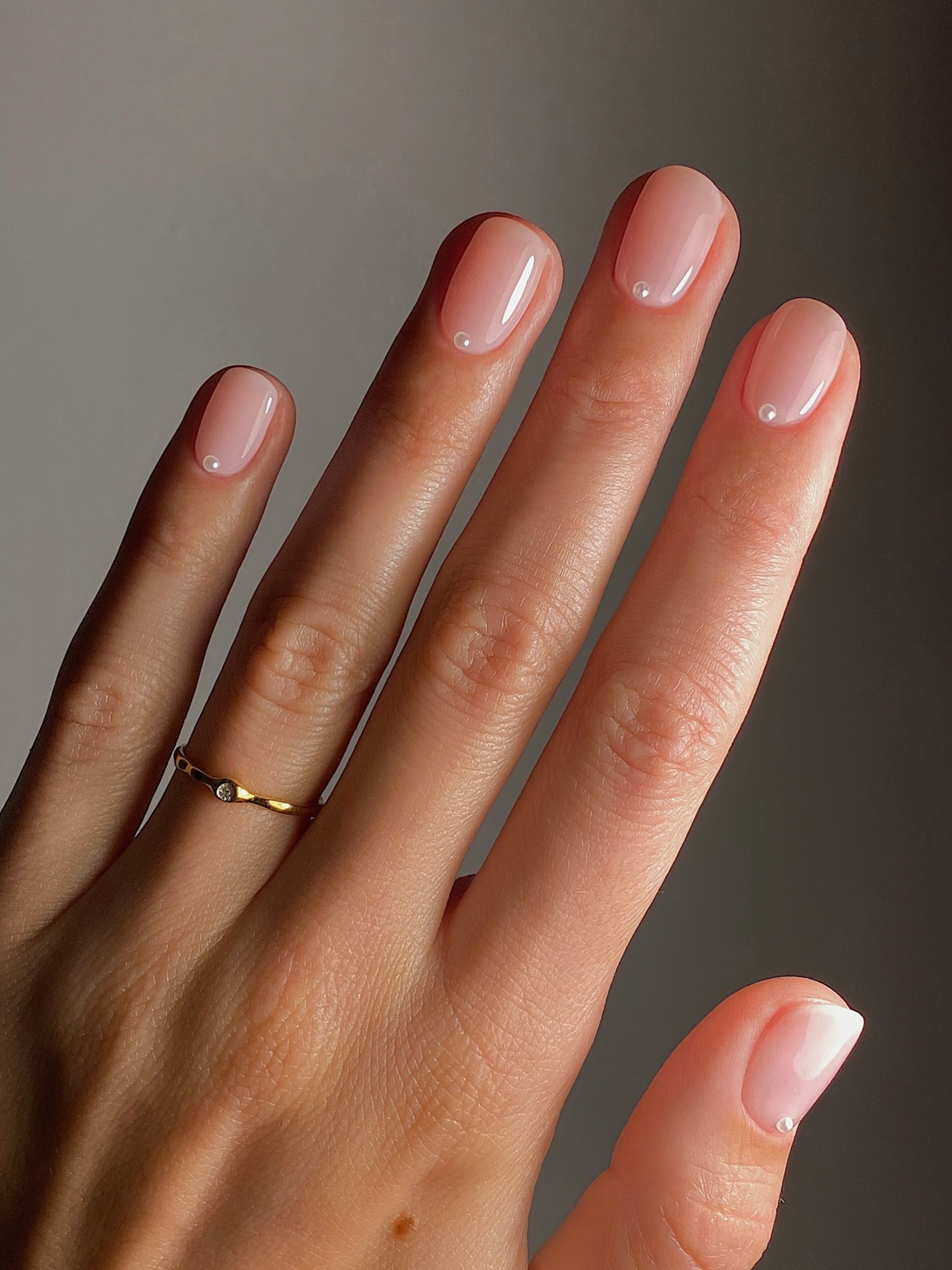 A pink manicure with pearl details by Mateja Novakovic
