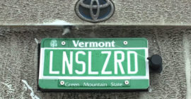 This backup camera cleaner hides behind your license plate