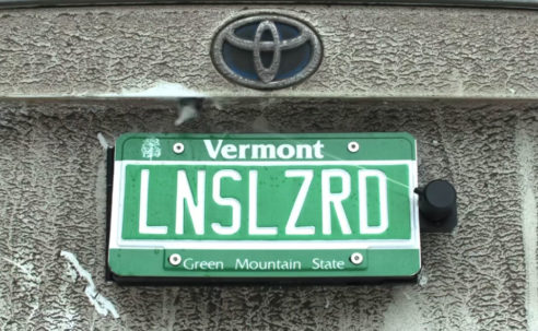 This backup camera cleaner hides behind your license plate