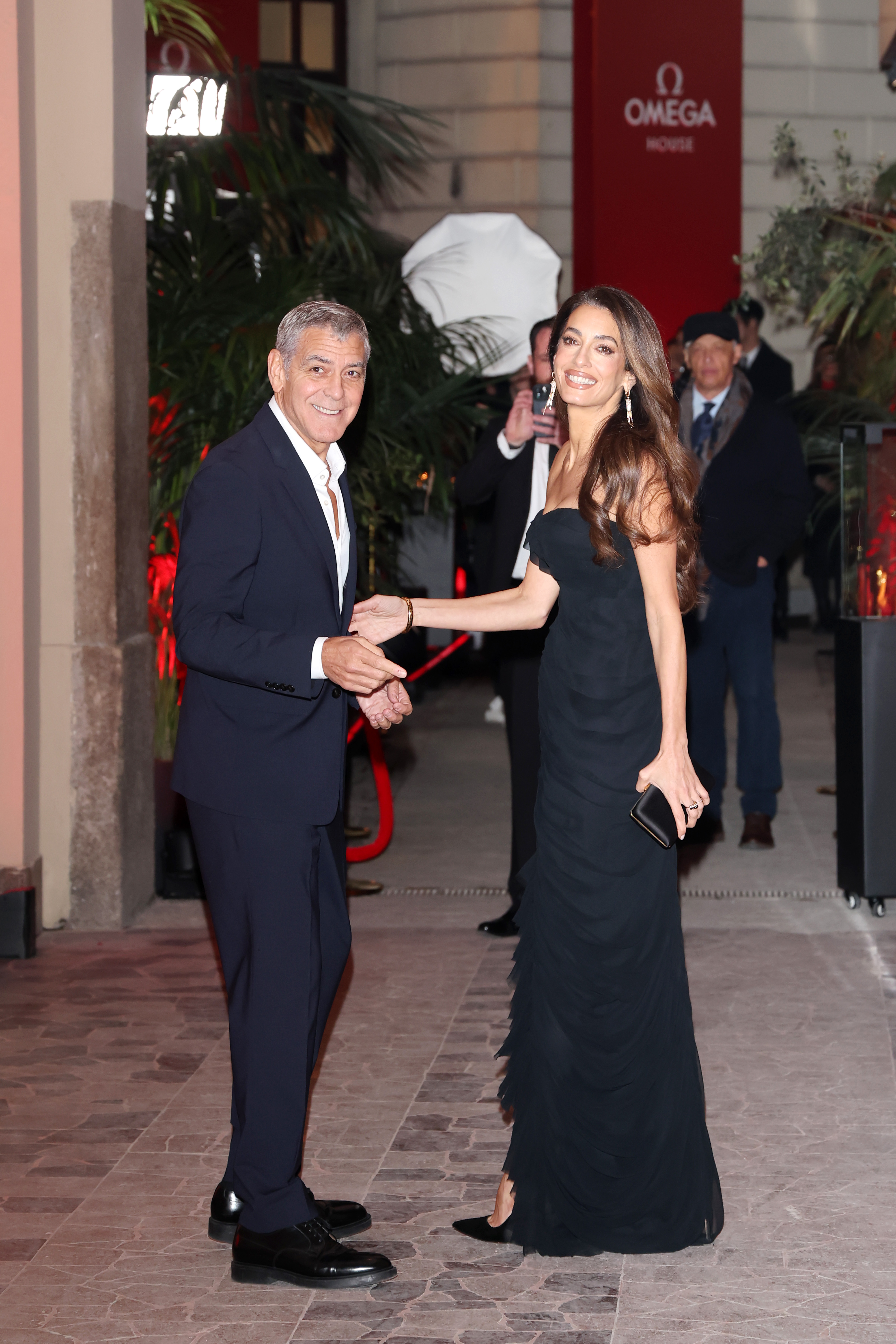 MILAN, ITALY - FEBRUARY 07: George Clooney and Amal Clooney attend the Omega House opening night during Milano Cortina 2026 Winter Olympics at Omega House on February 07, 2026 in Milan, . (Photo by Jacopo Raule/Getty Images)