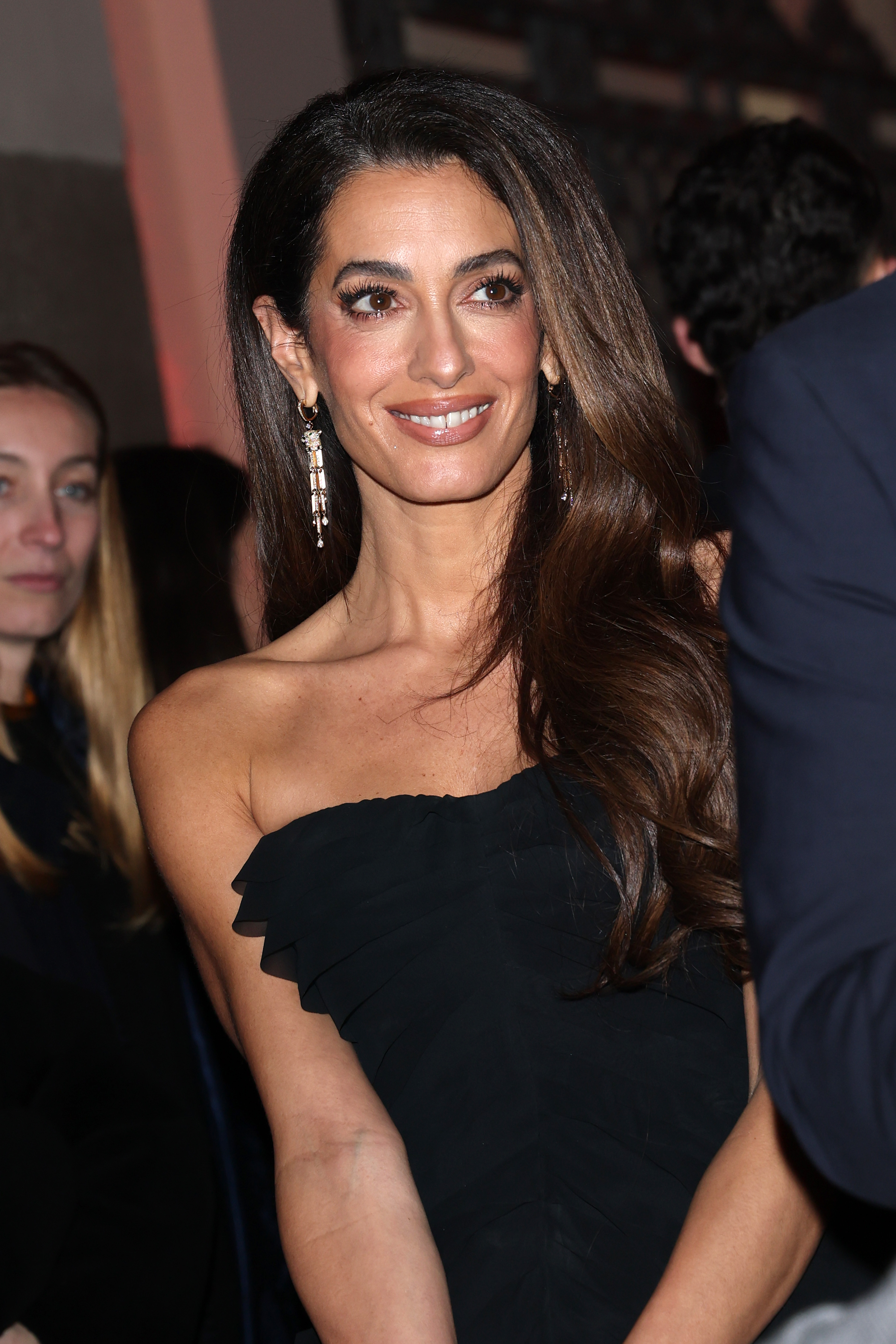Amal Clooney wears a black dress to Omega House in Milan