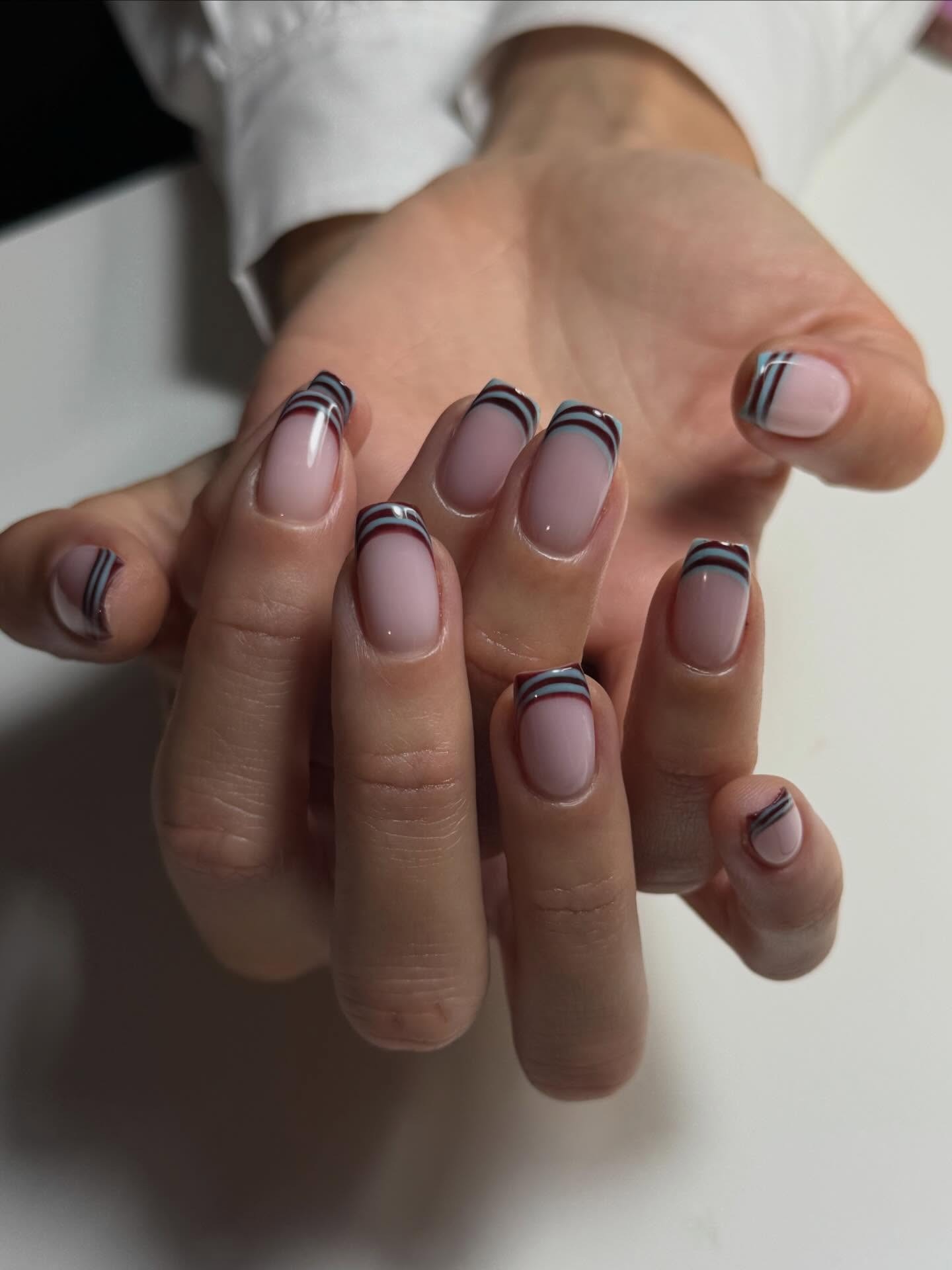 Striped blue and burgundy French tips.