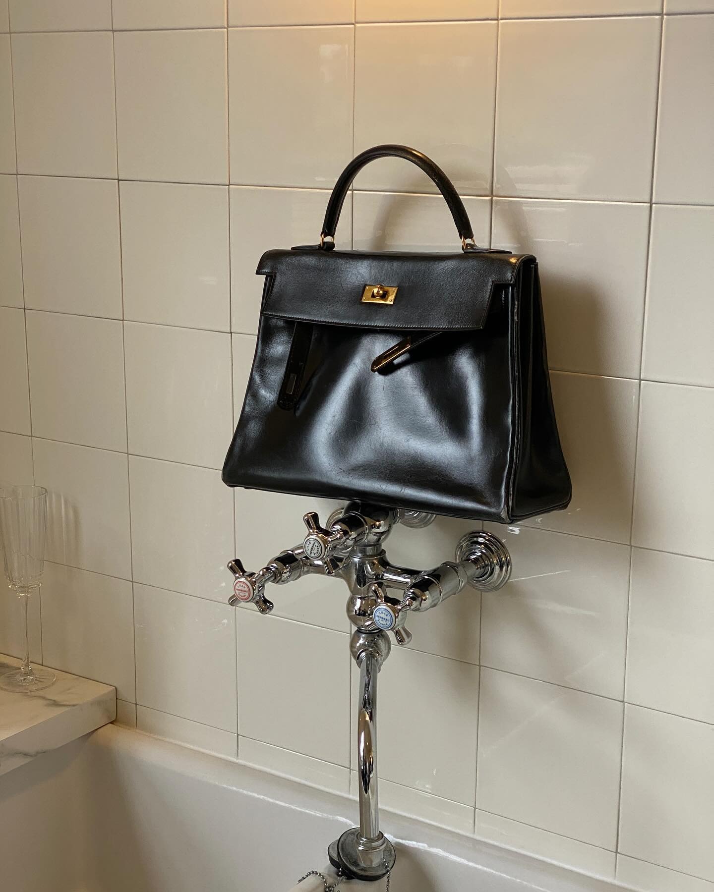 @christietyler taking a picture of a Hermes Kelly handbag