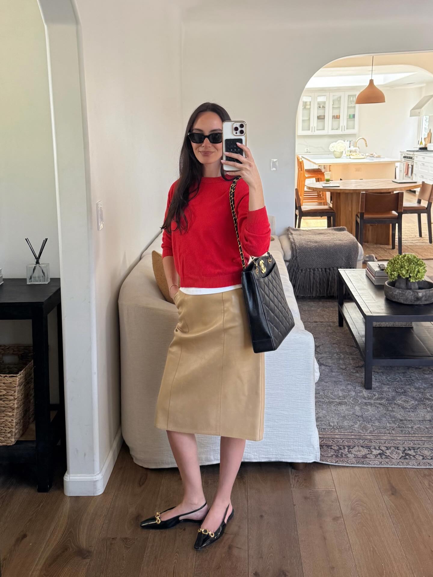 Influencer wearing a khaki knee-length skirt
