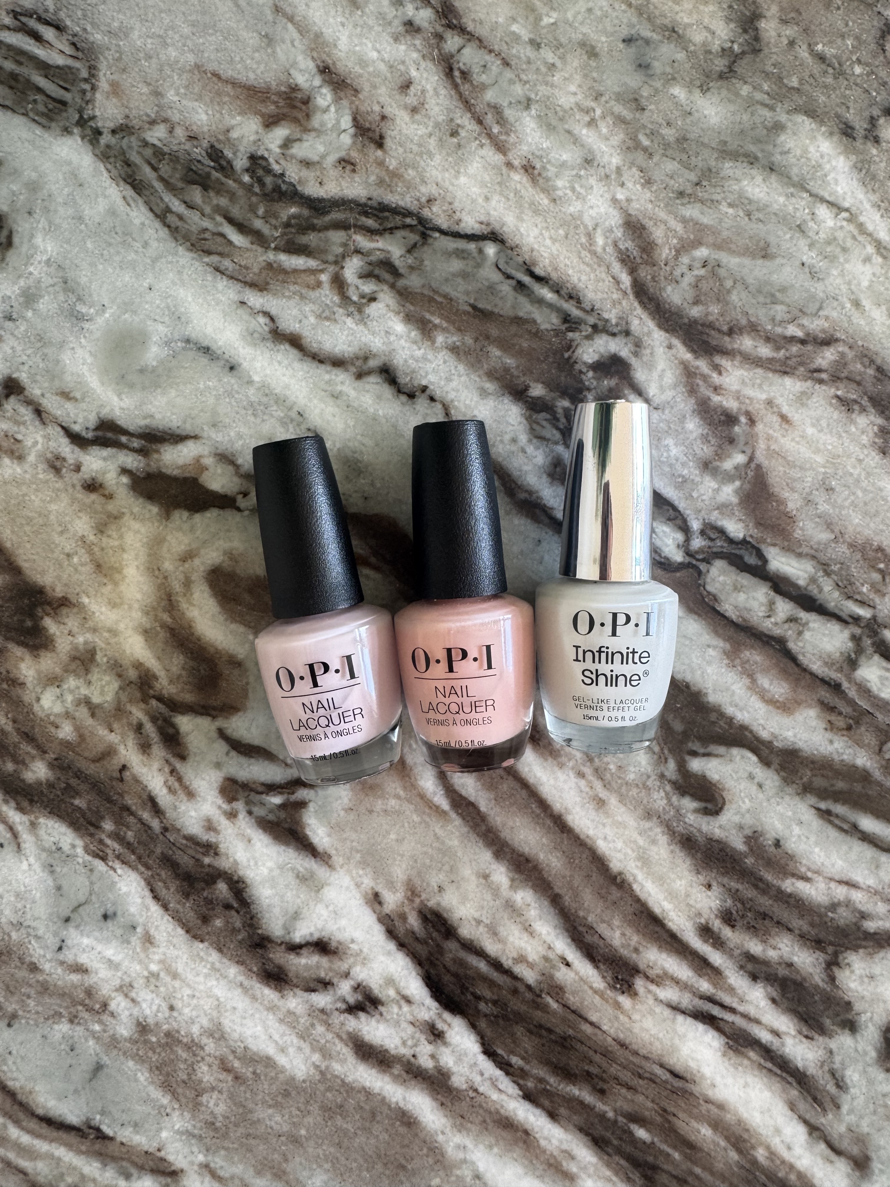 OPI'm a Bubble Bunny, Bubble Bath and Funny Bunny nail polishes on a marble table