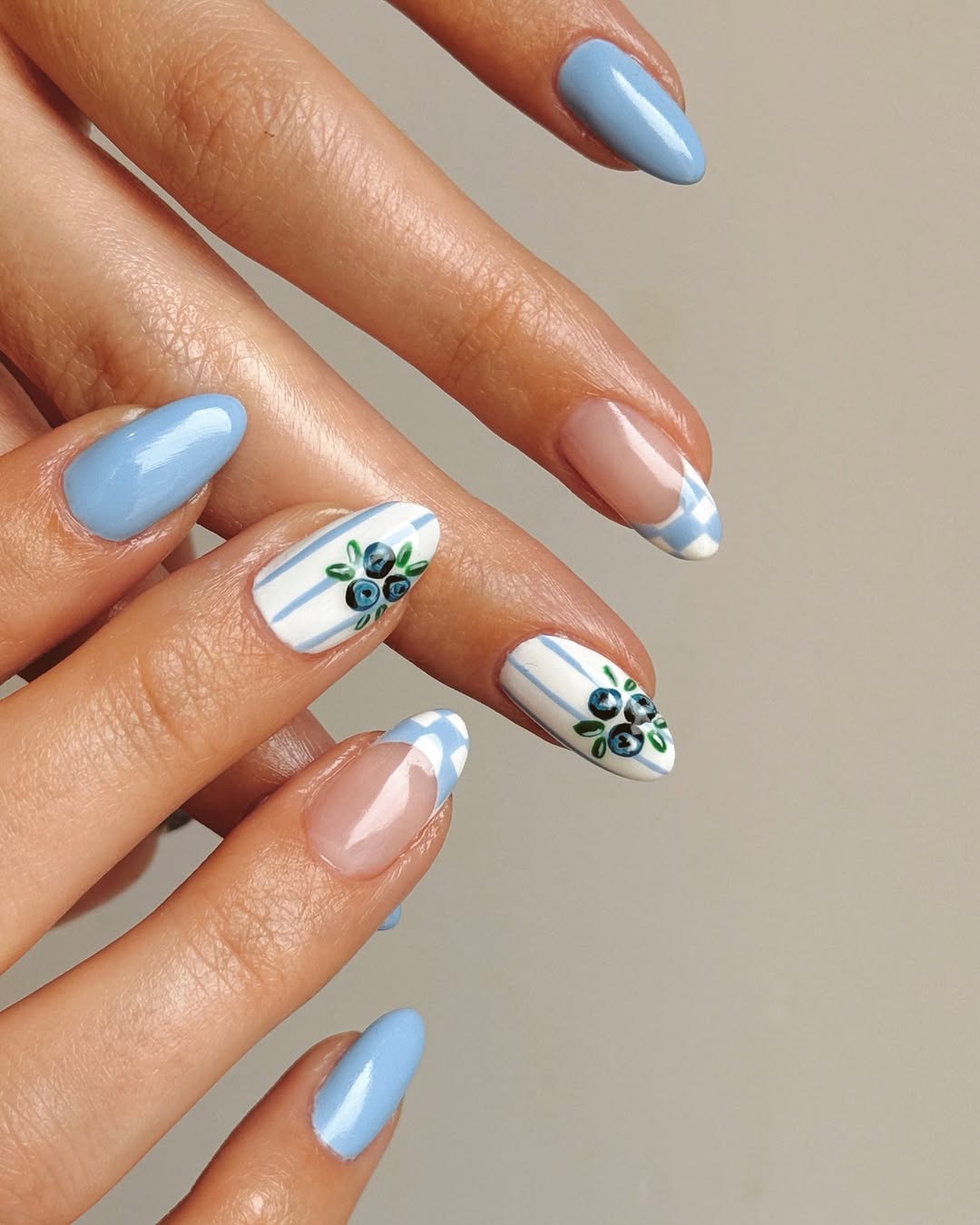 A manicure with gingham-inspired checker print tips by Queenie Nguyen
