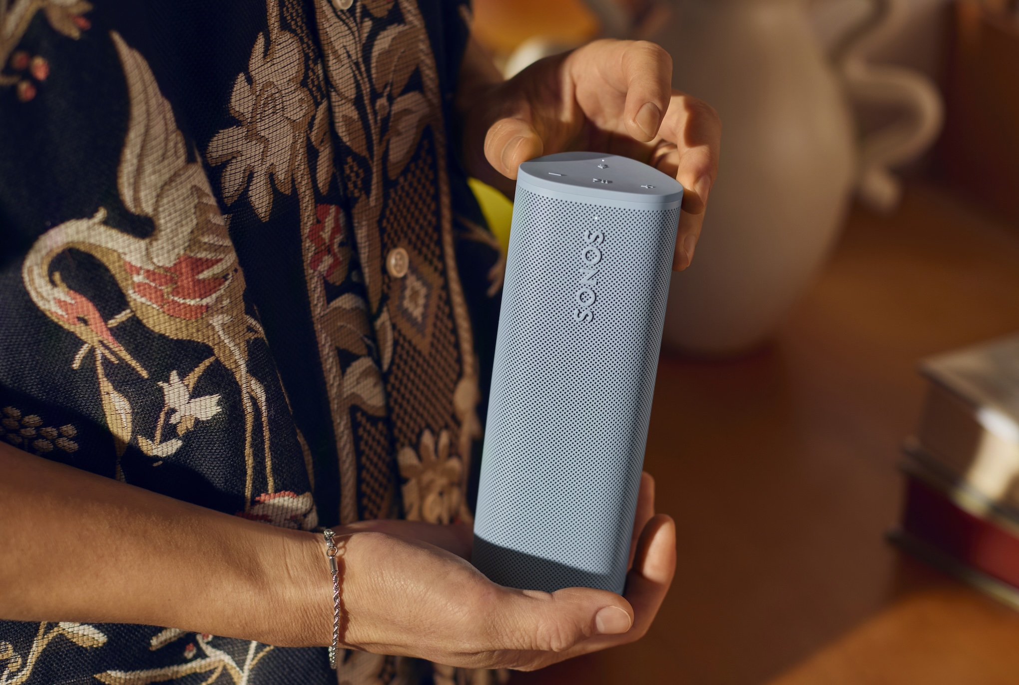 A marketing image of a blue Sonos Roam 2 speaker.