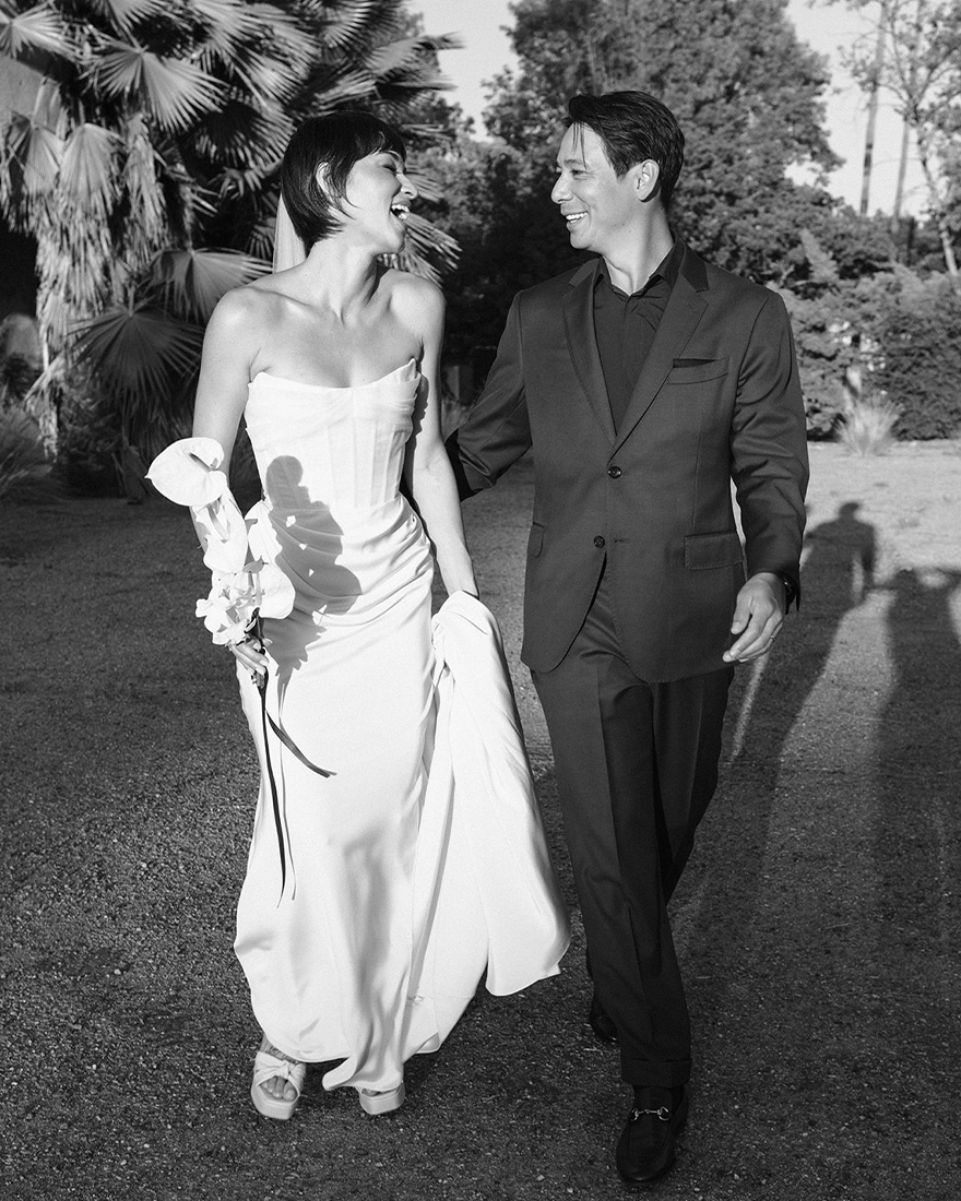 Britni and Sean wearing their wedding outfits and walking together.