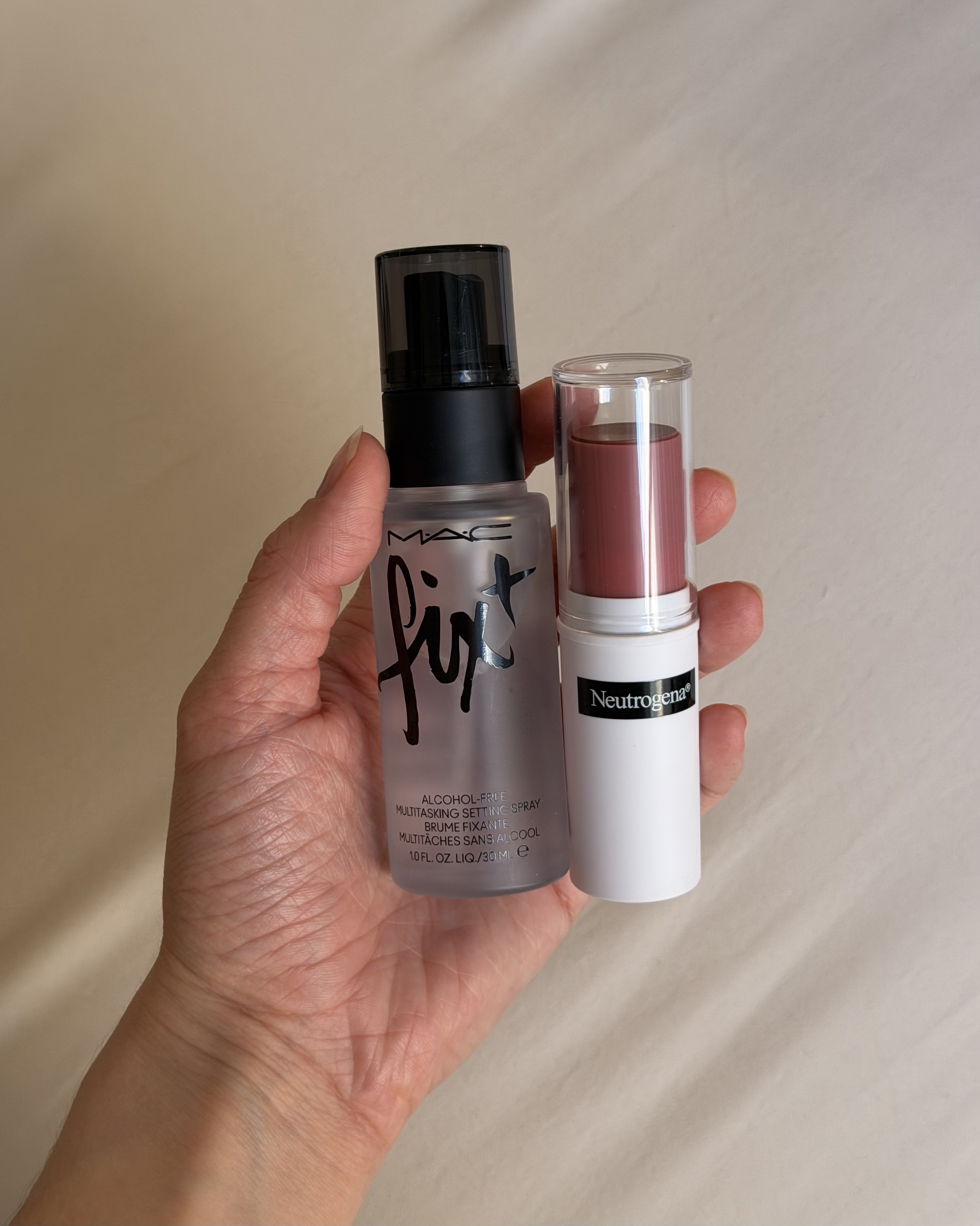 WWW associate beauty editor Alyssa Brascia holding MAC's Fix+ setting spray and the Neutrogena blush.
