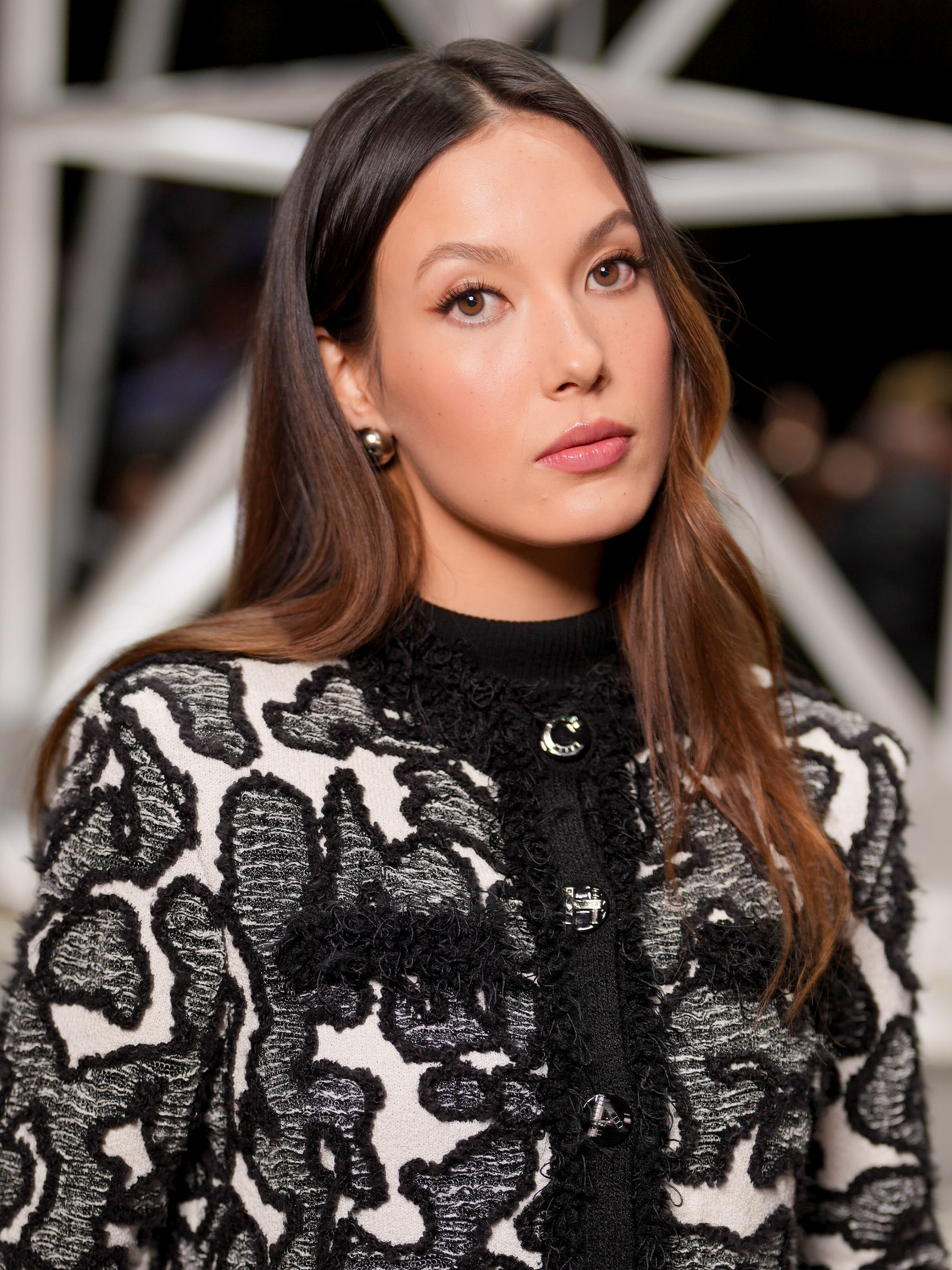 Eileen Gu at the Chanel fashion show as part of Paris Fashion Week Fall 2026 with caramel brown hair