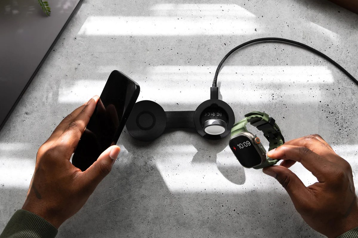 The Twelve South ButterFly SE 2-in-1 Qi2 Charger set up on a table with an iPhone and Apple Watch Ultra.