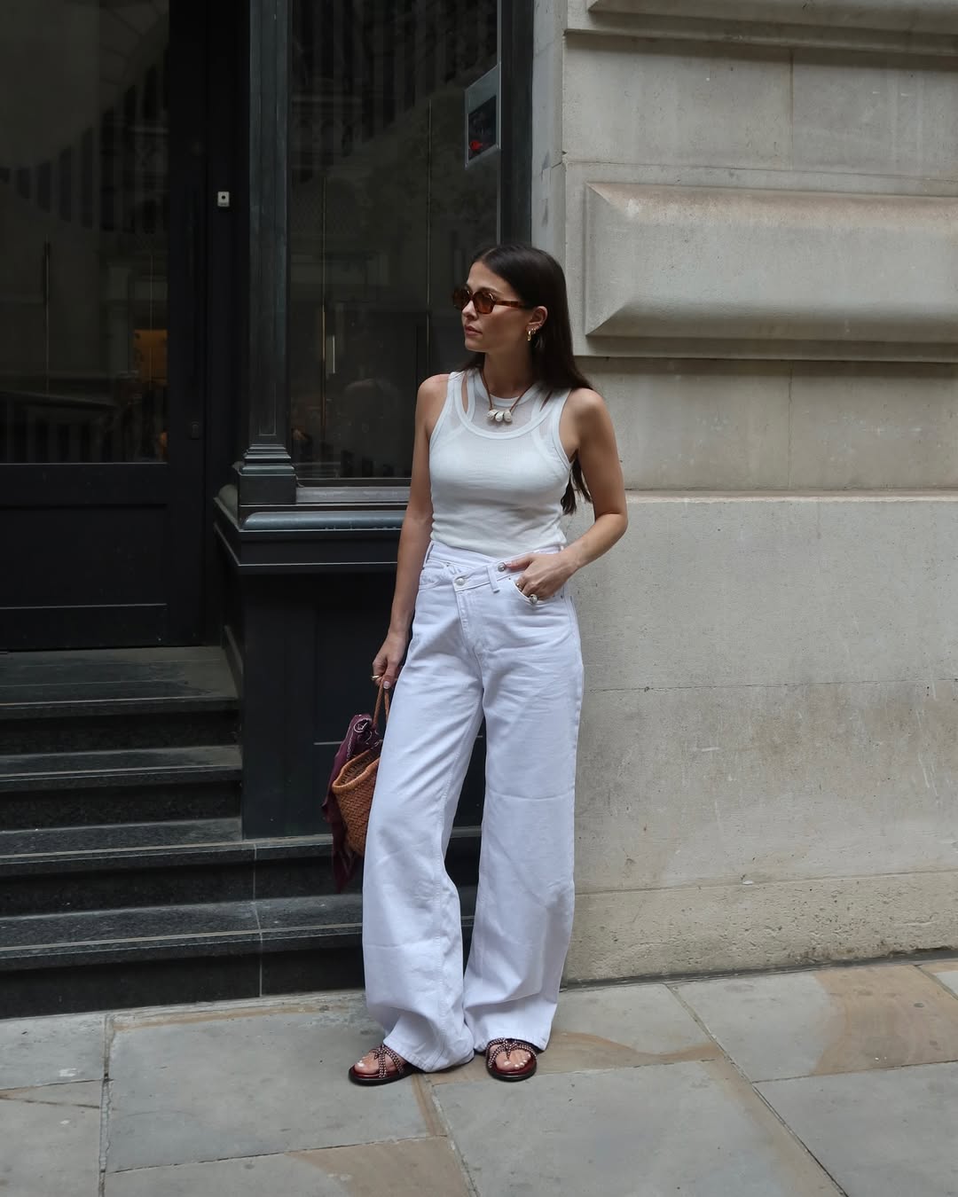Alice in white barrel jeans and rope sandals