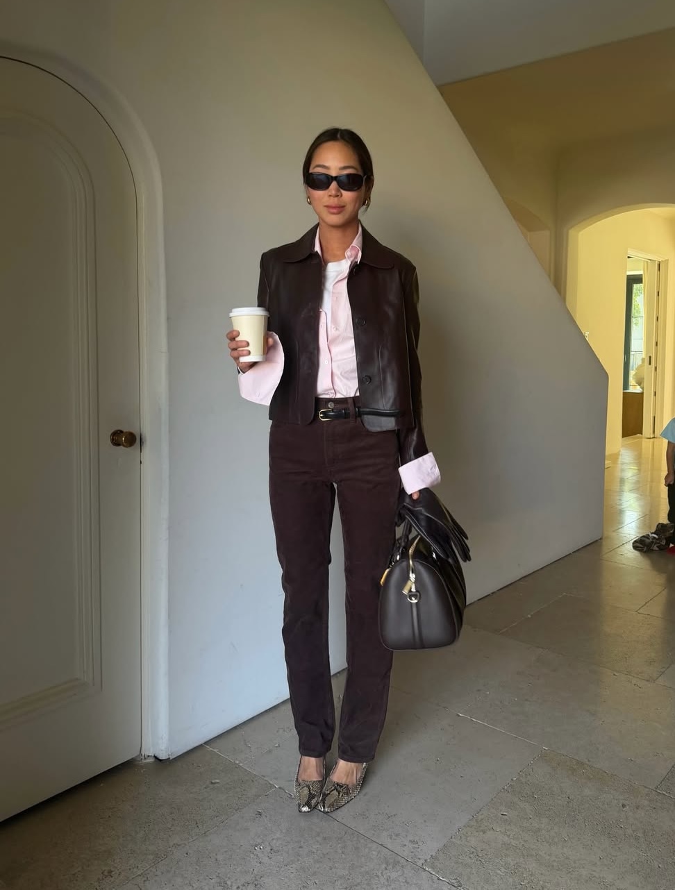 Aimee in brown jeans and pink shirt