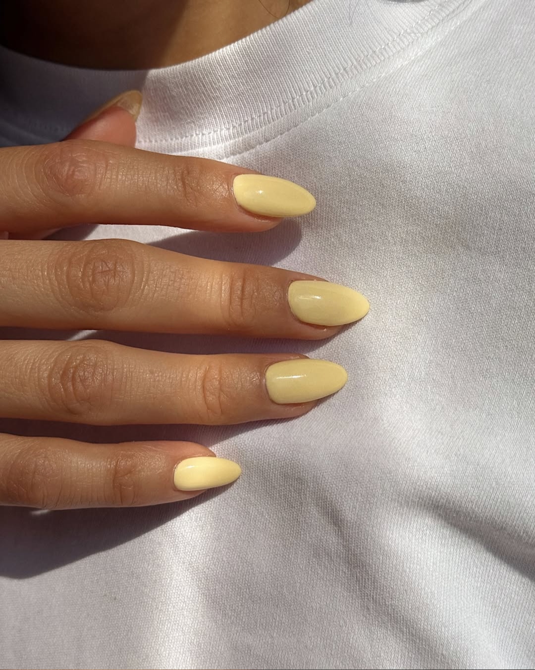 A buttercup yellow manicure by Queenie Nguyen