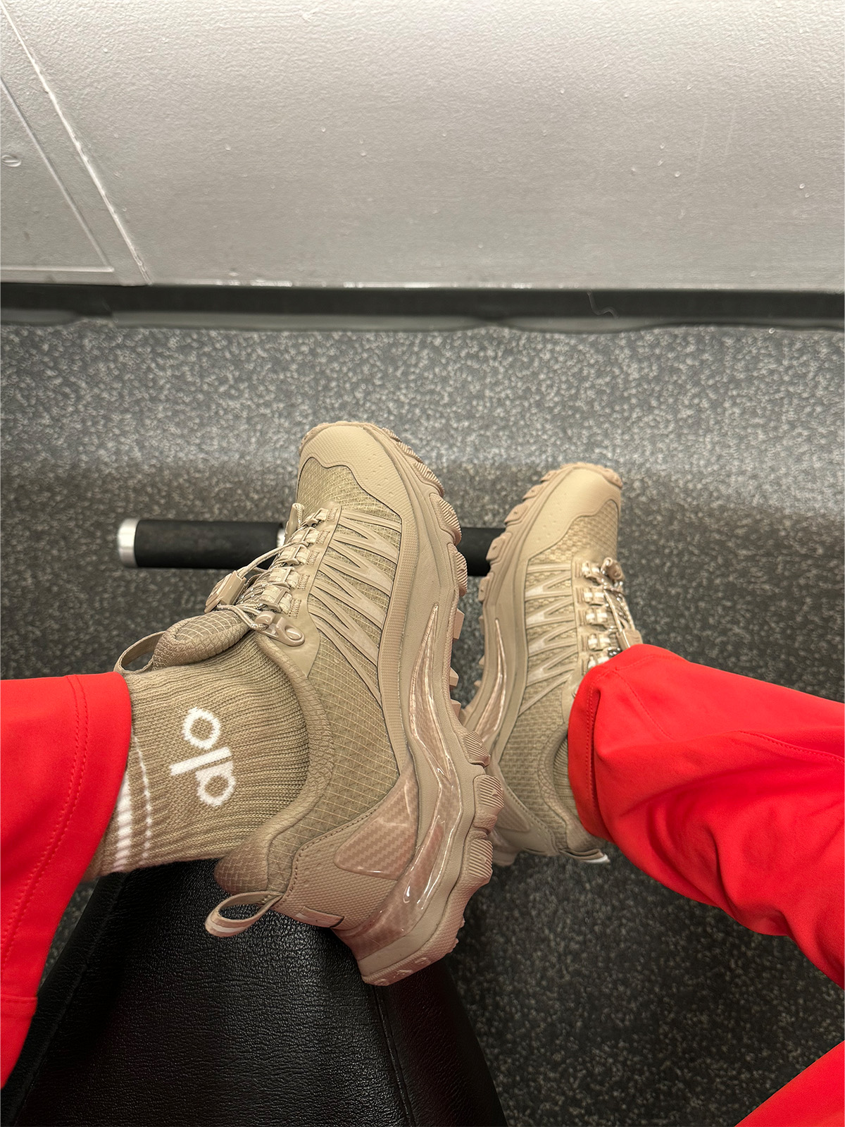 Nikki wears alo trail sneakers.