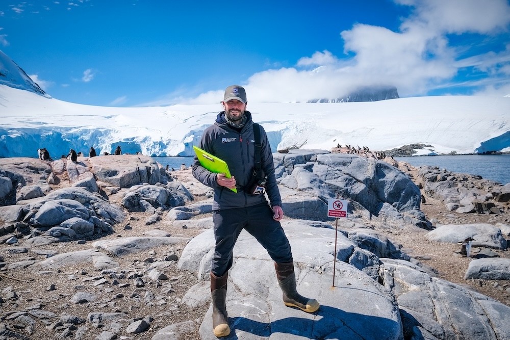 Peter with a clipboard working as the wildlife monitor in Antarctica