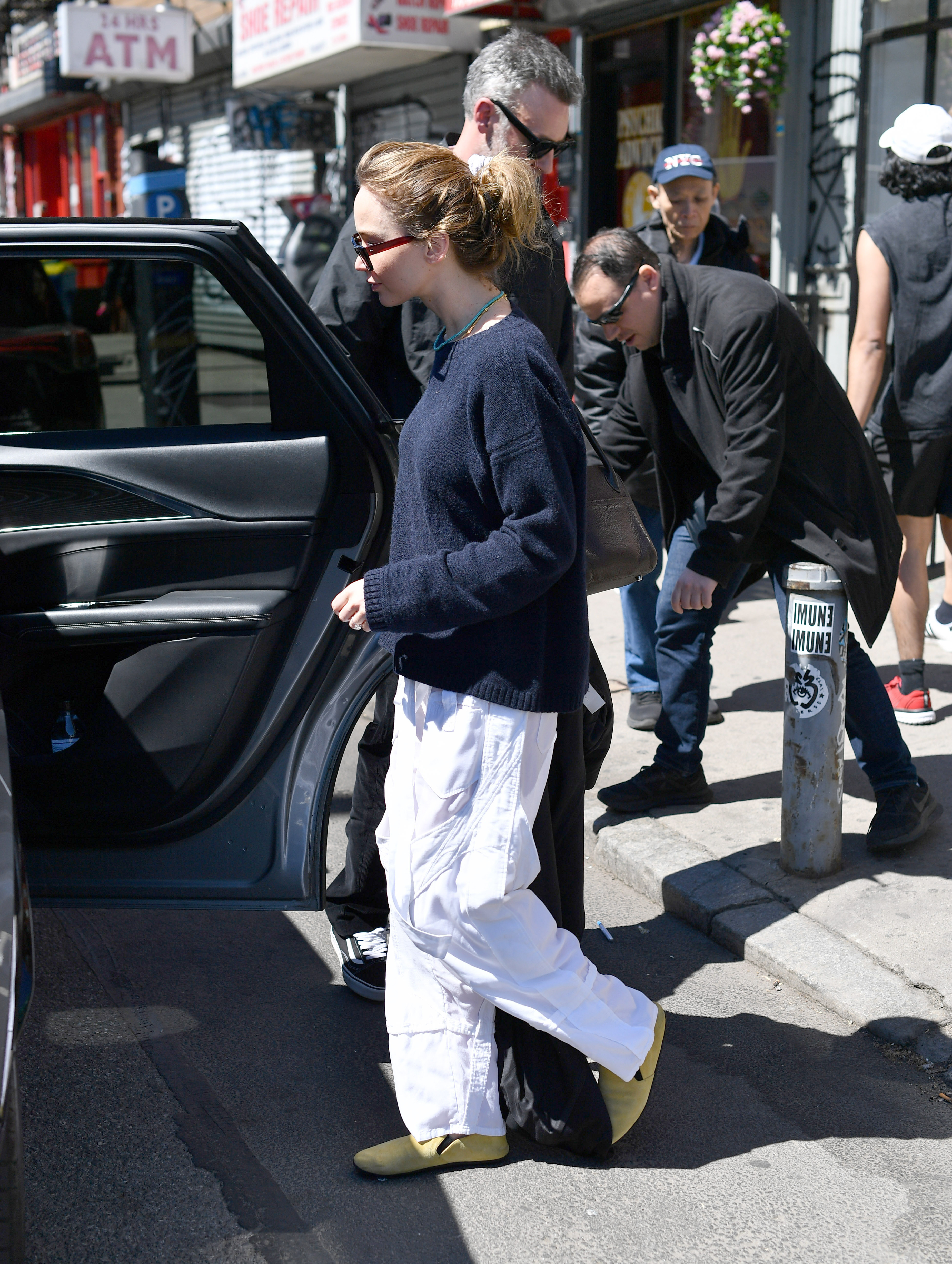 04/11/2026: Jennifer Lawrence and Cooke Maroney have a lunch date in New York City. Lawrence carried a black wool coat and wore a dark La Ligne sweater, white Balenciaga cargo pants, and yellow flats from The Row. The couple dined out at the famed ramen restaurant, Nakamura, in the Lower East Side.